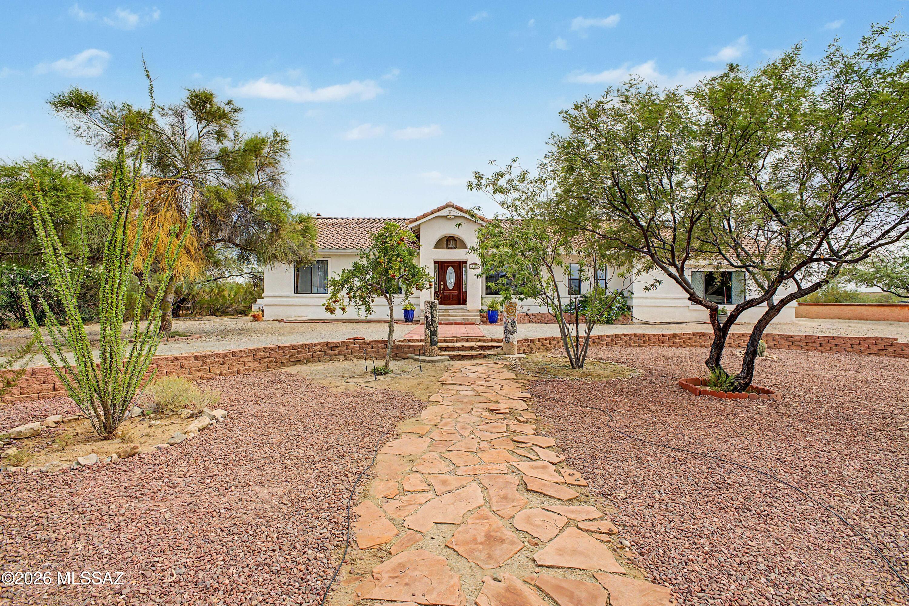 Rare Desert Retreat on Nearly One Acre - No HOA!

Experience the perfect combination of space, quality craftsmanship, and peaceful Arizona living in this exceptional 5-bedroom, 3.5-bathroom 3,809 Sq. Ft. home situated on one acre in a quiet, established neighborhood where every home resides on a .98-acre lot. With no HOA, outstanding privacy, and convenient access to shopping, dining, and highly rated schools just 10-15 minutes away, this property truly offers the best of both worlds.  

Designed for comfortable everyday living and memorable entertaining, the home features a spacious living room and a large kitchen with abundant cabinetry, generous counter space, and a cozy breakfast nook beneath a beautiful picture window that fills the room with natural light.

The finished basement offers incredible flexibility with a cozy family room centered on a welcoming fireplace, a spacious recreation room (approximately 400 sq/ft) perfect for games, hobbies, or a home theater,  approximately 320sq/ft storage room, and abundant storage throughout the home. Due to its impressive 8-inch-thick concrete basement walls, the lower level naturally stays cool during Arizona's hot summers and comfortably warm during the winter months.

Built with lasting quality in mind, this home features durable construction throughout, the 8-inch basement walls have 2-inches of insulation foam on both sides; the upstairs is constructed with 4-inch concrete walls 2 inches of foam on each side with a stucco finish that provides exceptional strength, energy efficiency, and long-term durability. 

Step outside and discover your own private desert sanctuary. The meticulously landscaped front yard creates outstanding curb appeal, while the backyard is a peaceful oasis that attracts hummingbirds and a wide variety of native Arizona birds. 

Enjoy morning coffee or evening gatherings on the expansive covered back porch overlooking the natural beauty of the property. Three handcrafted Southwestern metal gates add distinctive charm, while a digital timed sprinkler system keeps the landscaping thriving with minimal effort. 

The expansive lot provides endless opportunities to create your dream outdoor lifestyle, with ample room for a guest casita, swimming pool, horse corral, gardens, or additional recreational space. A large horse shoe driveway offers abundant parking for guests, RVs, trailers, and recreational vehicles, while the oversized two-car garage includes a dedicated workspace for projects, hobbies, or extra storage.

This is more than a home--it's a lifestyle. Offering no street lights the stars above shine bright on moonless nights. Peaceful desert surroundings, and unlimited potential, this rare property is ready to welcome its next owners.

Option to attend Cienega, Empire or Andrada High Schools.