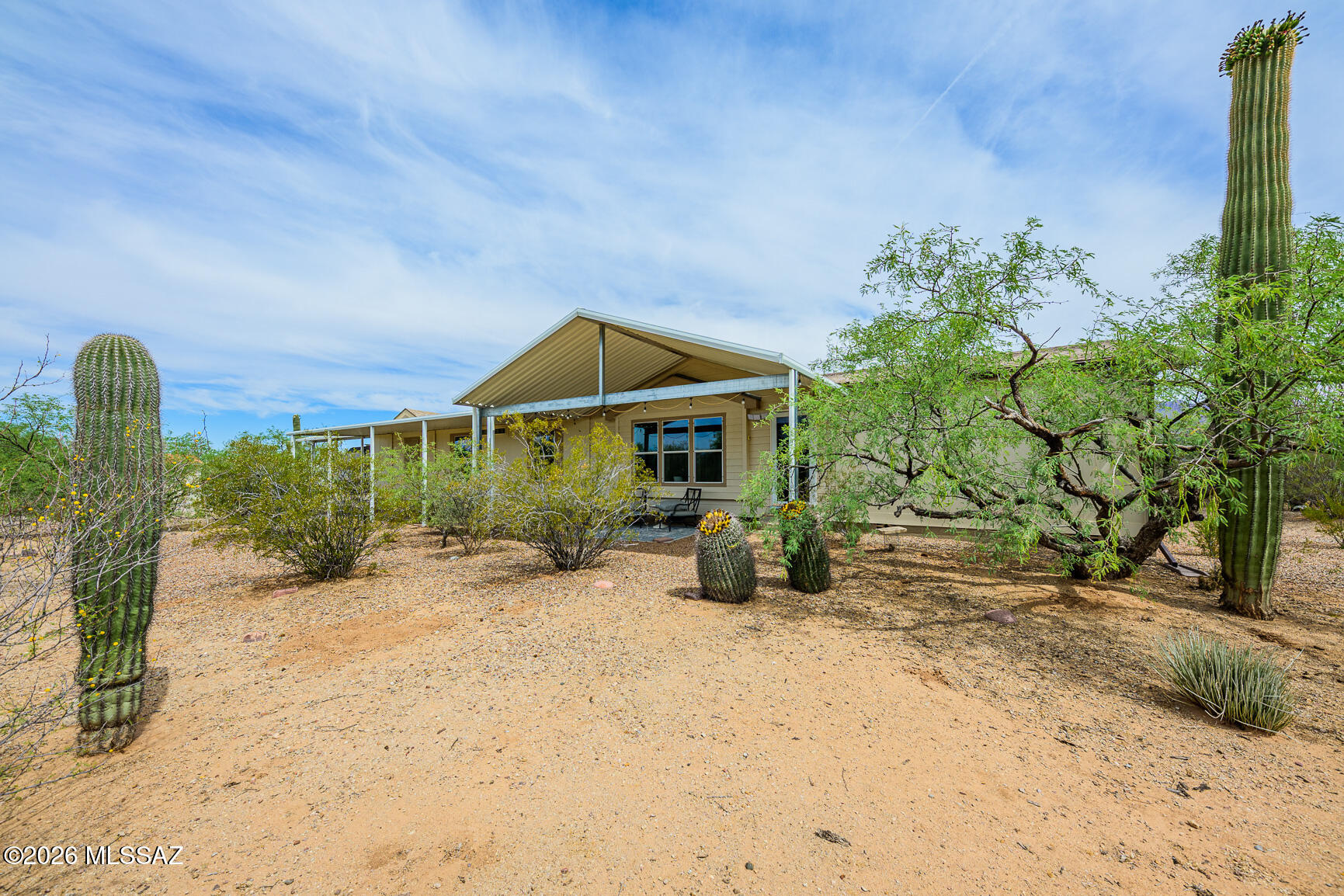 This stunning 3 bed, 3 bath home features OWNED solar and dual primary suites, offering flexibility and comfort for multi-generational living or guests. Tucked back off the street on nearly an acre (.94 acres) of natural desert landscape, this property delivers exceptional privacy and peaceful surroundings. Enjoy covered parking for up to 5 vehicles and numerous upgrades over the years including a new AC heat pump (2024), newer flooring in the living room and bathrooms, upgraded LED lighting throughout, and new ceiling fans with integrated LED lighting. The beautifully updated kitchen features new countertops, backsplash, sink, and a newer dishwasher. Two bathrooms have been refreshed with new countertops, and the primary bath includes a new sinks for a modern touch.