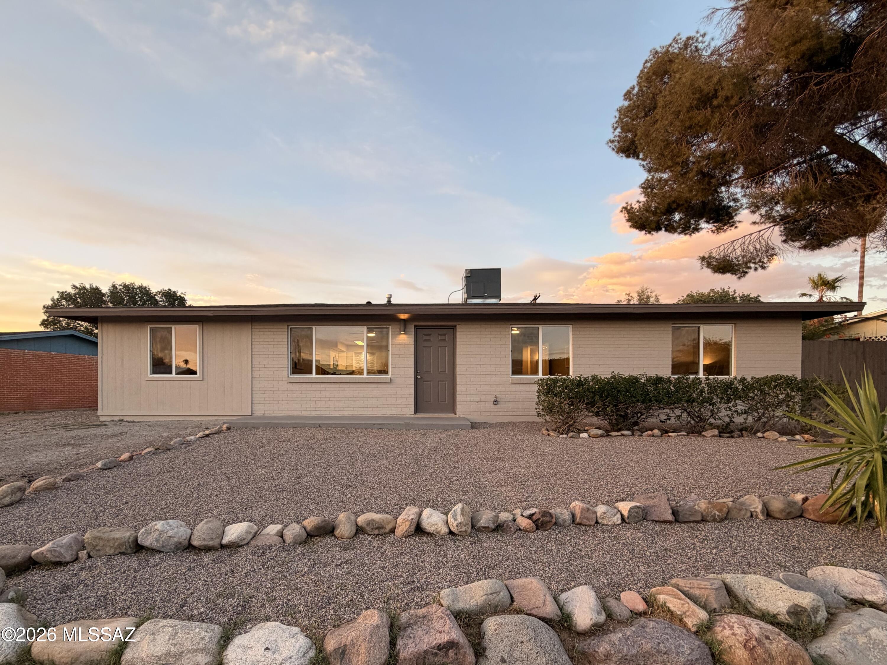Welcome Home to this meticulously remodeled 4 bedroom, 2 bath home with 2 bonus spaces in East Tucson. The aesthetic is clean and modern, featuring neutral colors, new white kitchen cabinets with granite tops, stone backsplash and SS appliances, modern light and plumbing fixtures, as well as brushed nickel ceiling fans in all the living and bedrooms. The 4th bedroom and oversized laundry room are on the other side of the living area, and the 2 flex spaces are off the dining area. Enjoy coffee in your covered and screened patio, or grow a garden on the side of the home. There are two access points for vehicles for the backyard: from the alley, and from the driveway. This house is free from worry as the roof, HVAC, paint, a lot of the drywall, floors, kitchen, baths, windows, doors, water heater, and more are new. This home has it all! Come. See. Stay!