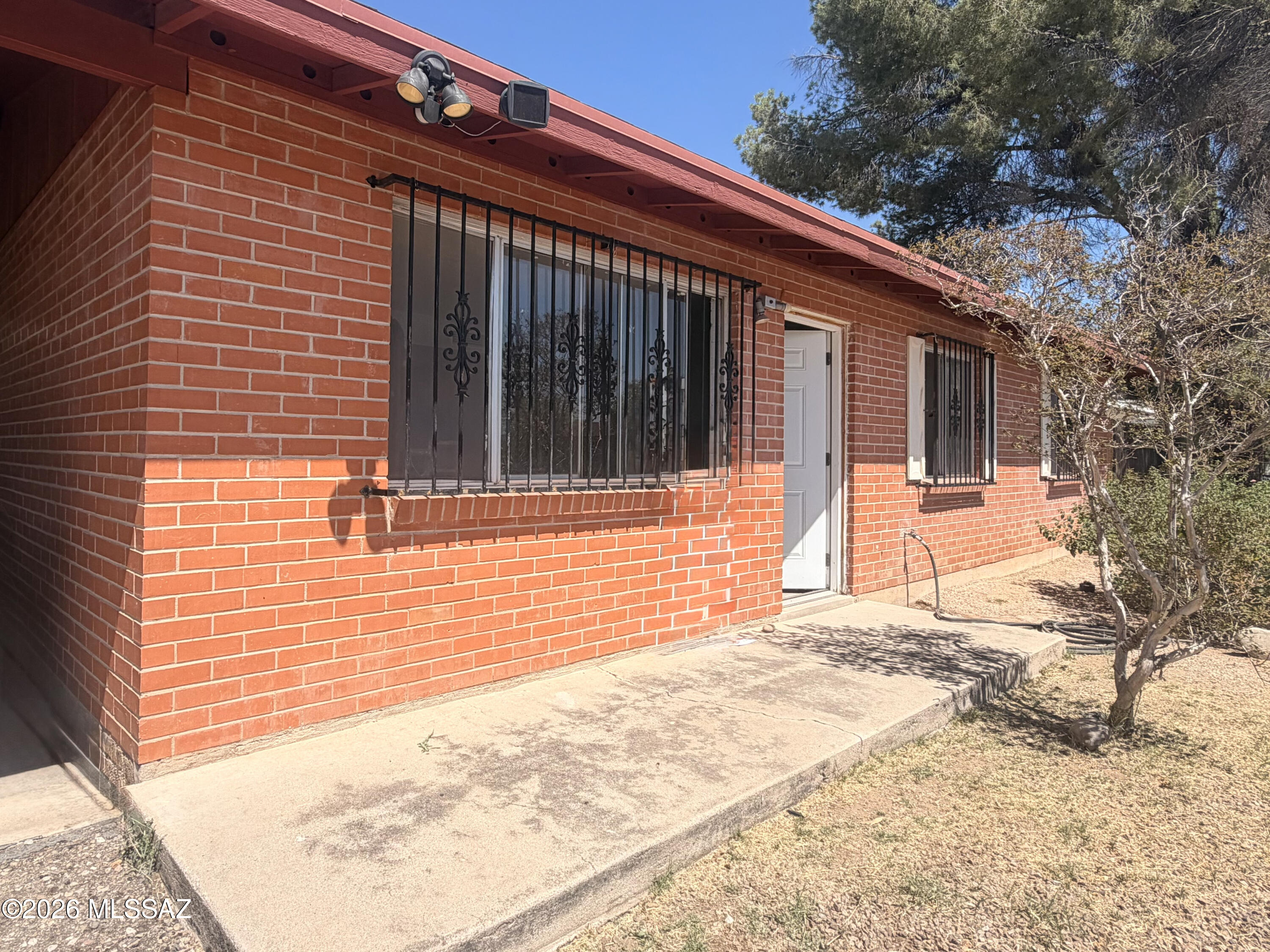 Welcome Home to this meticulously remodeled 4 bedroom, 2 bath home with 2 bonus spaces in East Tucson. The aesthetic is clean and modern, featuring neutral colors, new white kitchen cabinets with granite tops, stone backsplash and SS appliances, modern light and plumbing fixtures, as well as brushed nickel ceiling fans in all the living and bedrooms. The 4th bedroom and oversized laundry room are on the other side of the living area, and the 2 flex spaces are off the dining area. Enjoy coffee in your covered and screened patio, or grow a garden on the side of the home. There are two access points for vehicles for the backyard: from the alley, and from the driveway. This house is free from worry as the roof, HVAC, paint, a lot of the drywall, floors, kitchen, baths, windows, doors, water heater, and more are new. This home has it all! Come. See. Stay!