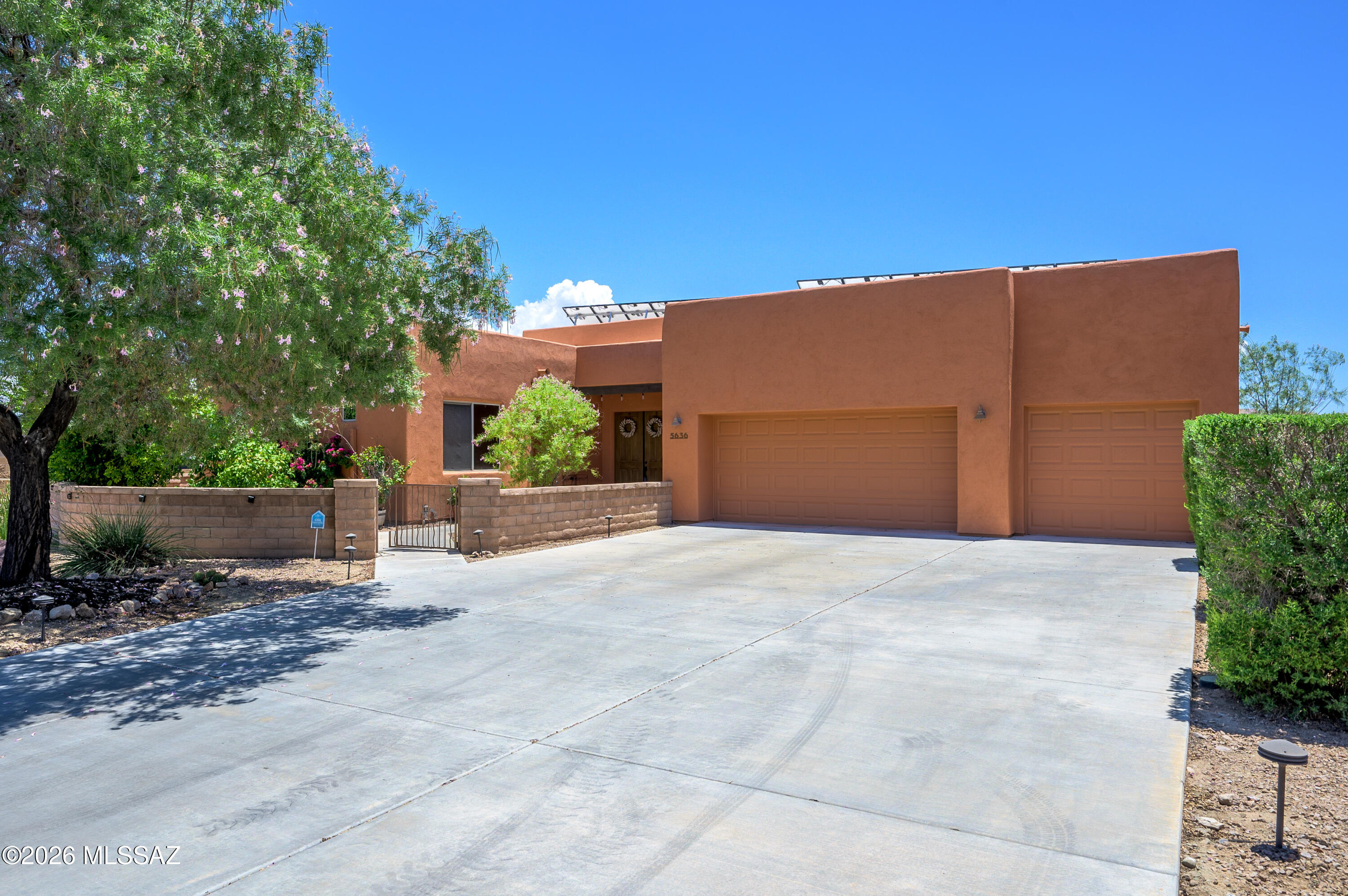 Welcome to the highly sought-after Civano subdivision on Tucson's Southeast side. This home is a rare gem within the community, as it is a premium lot featuring tons of privacy, an extended driveway, mountain views, no neighbors behind, and an adjacent wash on the left. And this home has an attached GUEST HOUSE with its own mini-split and a full bath!!

The home boasts a super-efficient solar system that generates 65 kilowatts of electricity daily, resulting in significantly reduced electric bills. And the best part: The solar panels are OWNED and PAID. The home also comes equipped with a bona fide top-of-the-line, best-you-can-buy 28 SEER HVAC system with 5-ton capacity and air filtration! The roof was recoated in 2025 as well. In 2021, an 8x8 HOT TUB and a 14' SWIM SPA were added. Whole-house water filtration with citrus filtration, tankless water heater, and a garage that's extended by 4' with 2 fans, built-in storage and a 50amp TESLA charger are just some of the other unique features. Yet there's so much more...

Inside, you have enhanced concrete flooring, 8" compared to your standard 4". The inside of the main home, guest quarters, and garage have been recently repainted. The kitchen has been updated with an attractive backsplash, decorative wood paneling has been added to the family room, and aromatic cedar has been installed in the primary walk-in closet. A mini-split system was installed in the primary bedroom to provide extra efficiency. The home is also equipped with all LED lighting, a stove vent with an automatic heat sensor, dual ovens, three closet pantries, cabinets for extra storage space in the laundry room, spray foam insulation for the garage, window tinting, and new exterior paint and wood staining as of 2025. Drip systems in front and back yards plus a garden bed has been added. Multiple fruit trees to enjoy providing shade, privacy, and delicious fruits, including limequat, lemon, pomelo and grapefruit. 

What makes this home even better is that it is located in one of the best subdivisions designed with principles of sustainability, such as goals for gas and water reduction, recycling, reduced automobile use, and affordability. They even have their own schools, with a K-5 and a Middle School. There are tons of amenities, including two pools and spas, a huge recreation center, myriad walking paths, tennis, pickleball, soccer, a large community park, its own community café and market, community garden, and so much more. Not only that, the home is minutes away from Saguaro National East with a slew of great hiking trails. Come see what practical and luxury desert living is like!! Make an appointment to see today!