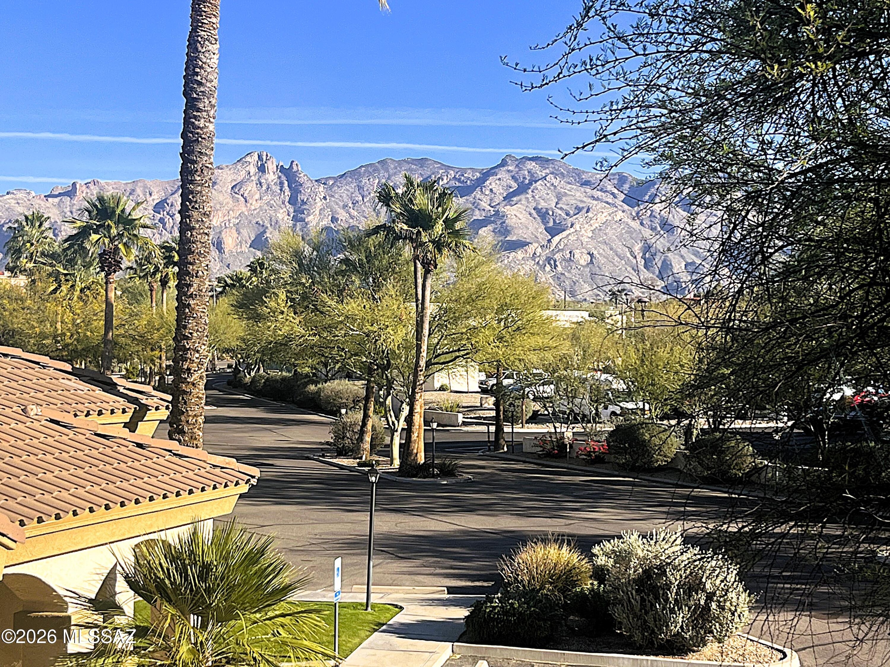 Soak in breathtaking mountain views from this gorgeous, move-in-ready condo located in the desirable gated Haciendas del Sol community. This 2-bedroom, 2-bath condo features a private balcony and has been beautifully refreshed with fresh interior paint, brand-new carpet, granite kitchen countertops, stainless steel appliances, and plenty of cabinetry. The inviting living space is warm and welcoming, anchored by a cozy gas fireplace, perfect for relaxing evenings or entertaining guests.  The spacious primary suite offers a large walk-in closet and sliding doors that open directly to the balcony, creating the perfect spot to enjoy morning coffee or simply take in the lovely mountain views.  The bright guest bedroom also enjoys balcony access and is conveniently located near the guest bathroom with a tub/shower combo. Residents of Haciendas del Sol enjoy resort-style amenities, including a sparkling pool, spa, fitness center, and clubhouse. Ideally situated just minutes from shopping, dining, and the Rillito River Path, this home offers the perfect balance of scenery, comfort, and convenience. Incredible views, a resort lifestyle, and a prime location this one truly has it all.