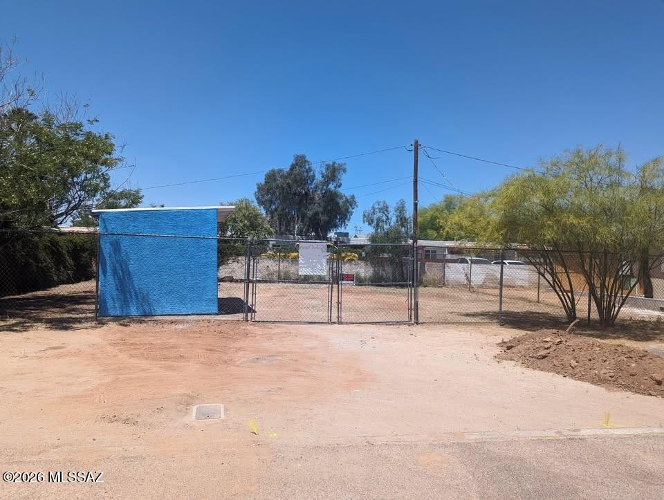 This 3,615-square-foot lot features 6-foot chain link fencing on all sides.  There is water service on the lot and sewer available. TEP power and Cox Communications are available.  This lot previously had a house. Additionally, there's a secure shed on-site.  This lot is conveniently located ten minutes from the University of Arizona, Downtown, shopping, and entertainment.  Financing available with a substantial down payment.  Submit all offers!  Owner-Agent
