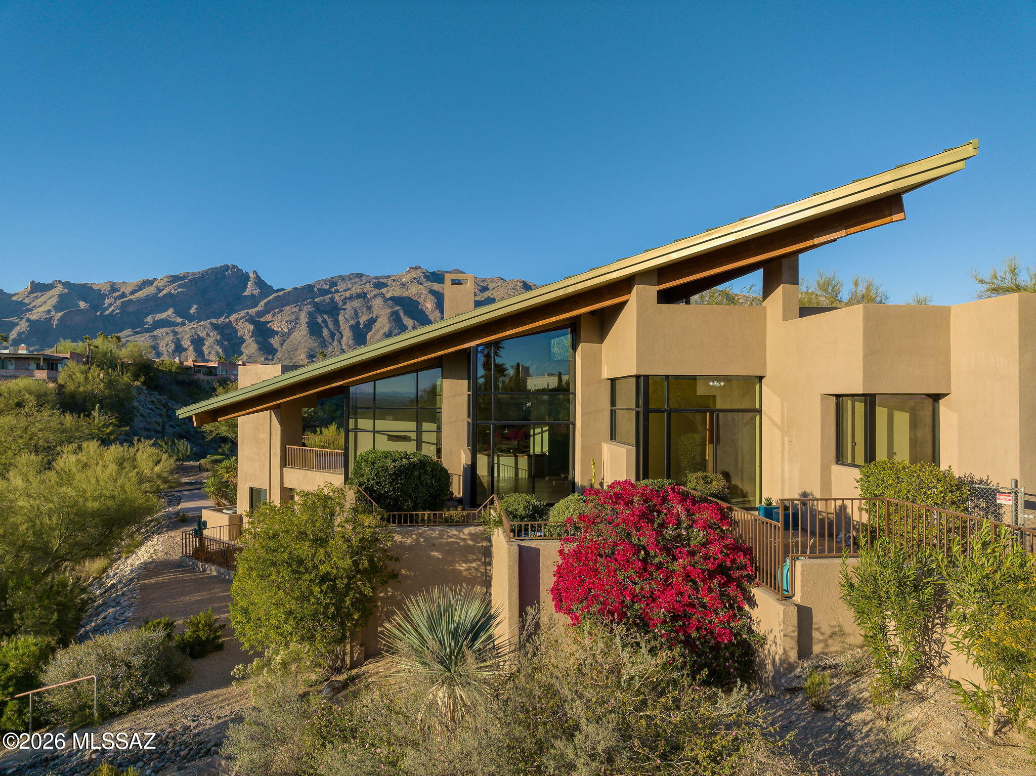 Sweeping City & Mountain Views From this Ideal Central Foothills Location in The Gated Enclave of Swan Ridge. Fine Features of This 3BR & 3BA 3,600 SqFt Custom Home Include: Spacious Light Filled Great Room w/Vaulted Ceilings, Fireplace, & City Views - Island Kitchen & Dining Area Framed by Commanding Mountain Views - Executive Office/Den - Powder Room -  Two Spacious Primary En Suites & Versatile Lower-Level En Suite w/ Adjacent Bonus Room - Large Laundry Room w/Sink - Oversized 3-car Garage & Abundant Storage Throughout. Private Outdoor Living Spaces Including Multiple Patios, Covered Balcony w/ BBQ All Showcasing Incredible City & Mountain Views. Close to Shopping, Dining, Golf, Hiking, Country Clubs/Resorts, & Central Tucson. District 16 Schools. Estate Sale