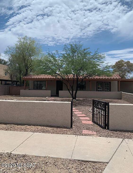 Spacious 3 bedroom, 2 bathroom home with 2 additional bonus rooms, offering 1,616 sq. ft. of versatile living space in central Tucson. This unique home features a split-bedroom floor plan with a private primary suite entrance and an oversized walk-in closet. Laminate wood flooring runs throughout the main living areas, while the bedrooms offer carpet and the bathrooms and first bonus room feature ceramic tile. The kitchen comes equipped with a refrigerator, gas cooktop, dishwasher, and disposal, providing both functionality and convenience. Enjoy a large beautifully landscaped front yard and a full-length covered patio that is perfect for relaxing or hosting BBQs. Additional features include air conditioning, ceiling fans, laundry hookups, window coverings, and a fenced yard.