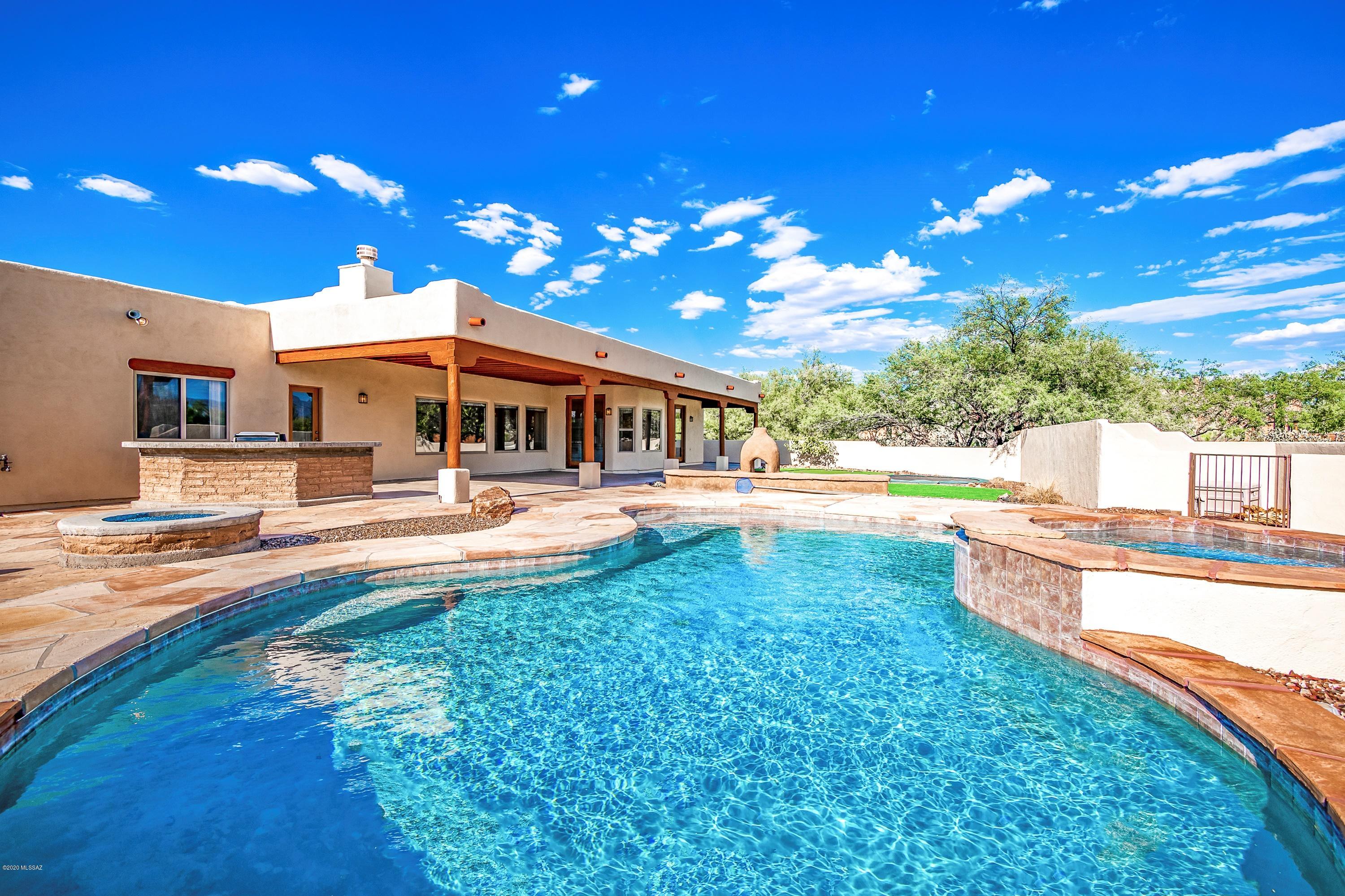 Beautiful Southwest Santa Fe style home located in gated community with resort-like backyard amenities; which include a large covered patio, sparkling pool, spa, built-in bbq and even a putting green!  Amazing mountain views. Private primary suite offers a large jetted tub, walk-in shower, dual vanity, large walk-in closet & access to patio.  Split floor plan with 2  bedrooms offering a jack n jill bath.  Plus a bonus room, guest bath and office.  Spacious Great Room opens to the kitchen.  3 car garage, laundry room and washer/dryer included.