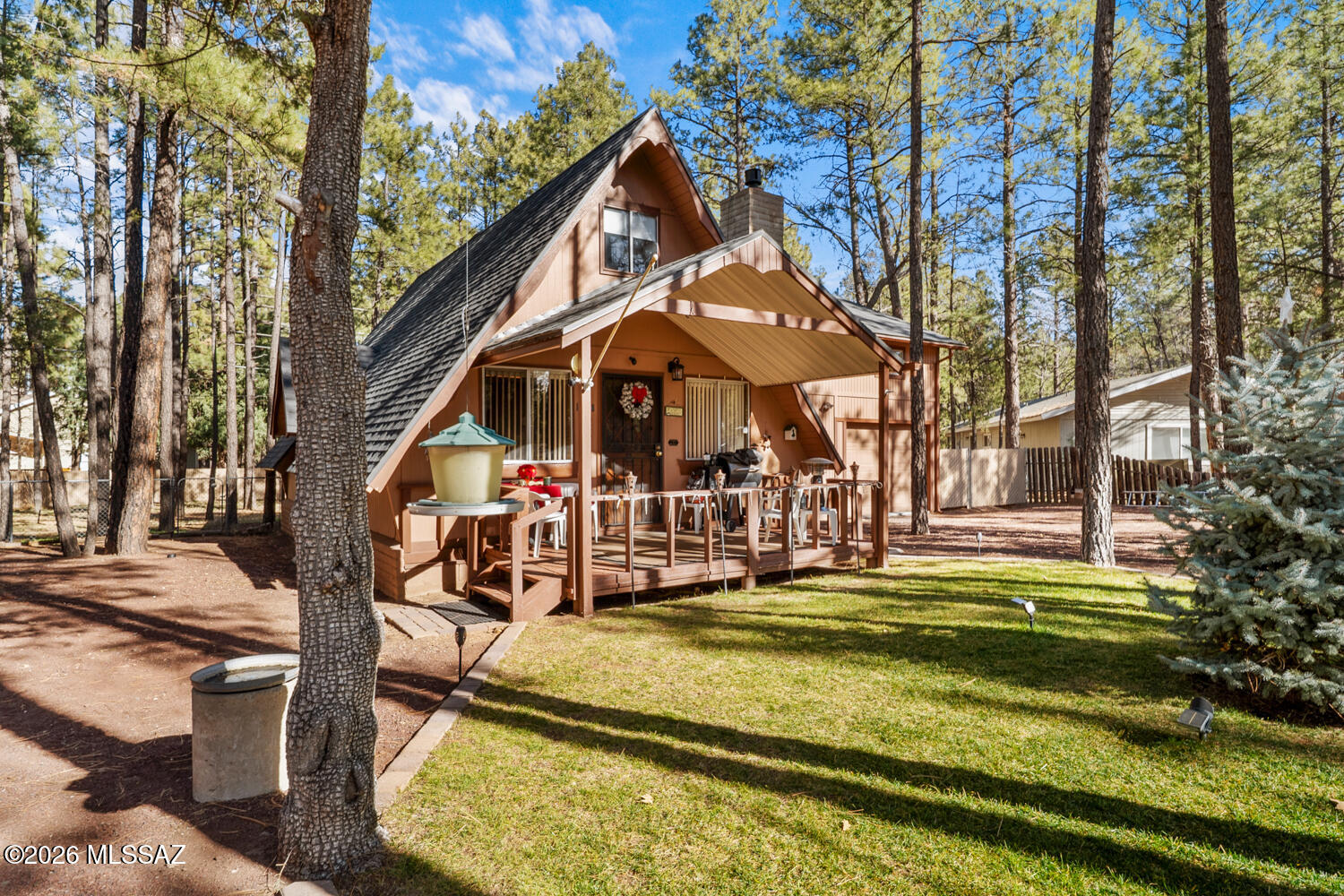 Nestled among the pines, this 4-bedroom, 2.5-bath home offers 1,967 sq ft of comfortable mountain living on a large lot with no HOA. The updated kitchen provides modern functionality while maintaining a warm, inviting feel. A gas fireplace anchors the main living area, and a versatile loft adds flexible living or workspace options. Additional features include a 1-car garage, RV hookup for sewer/water, two water heaters, a rear deck overlooking the wooded setting, and a front patio ideal for relaxing. Surrounded by tall pines, the property offers a peaceful atmosphere while remaining conveniently close to local lakes, shopping, dining, and year-round recreation. An excellent opportunity for a full-time residence, second home, or mountain getaway in Lakeside.