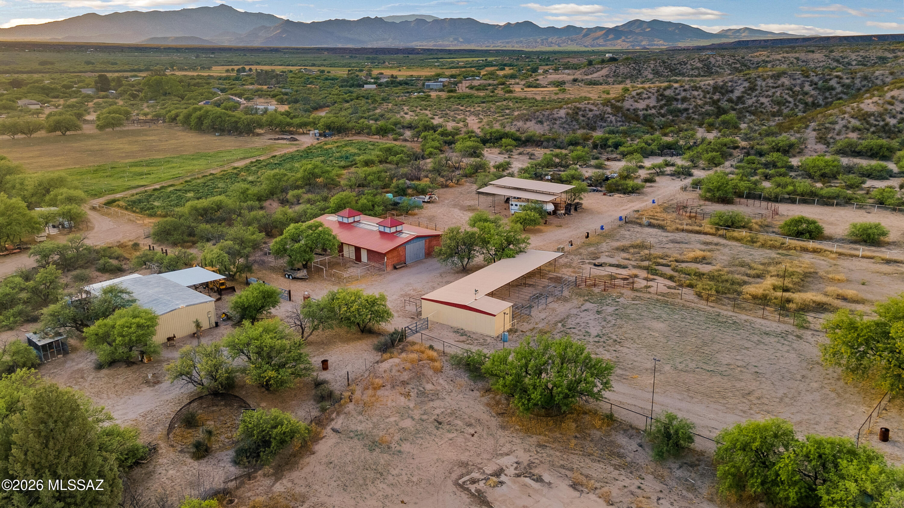 DO NOT CONTACT SELLER Welcome to an extraordinary opportunity in the serene countryside of Pomerene Park in Benson, Arizona-where wide-open skies, peaceful desert landscapes, and endless potential come together on this remarkable 8.33-acre estate. This rare offering is truly a one-of-a-kind property designed for those seeking space, versatility, and the ultimate rural lifestyle, whether for full-time living, equestrian pursuits, or a private weekend retreat. As you arrive, you're immediately greeted by a long, private approach enhanced by a substantial straw bale wall with a stucco finsh along Pomerene Road-fully
paved-providing both privacy and a sense of arrival. Beyond the entrance, the property unfolds into a beautifully maintained desert oasis that perfectly balances convenience with seclusion. Despite its tranquil setting, you just minutes from the heart of Benson and approximately 45 minutes from Tucson, making it an ideal blend of rural charm and accessibility. The property features two separate living quarters, offering flexibility for multi-generational living, rental income, or a dedicated caretaker setup. The main residence welcomes you with recent upgrades, including a newer metal roof, and provides a comfortable living space ready to enjoy or expand upon. The guest house spans approximately 1,100 square feet and includes 2 bedrooms and 1 bathroom--perfect for extended family, guests, or on-site help. Equestrian enthusiasts will immediately recognize the exceptional value in the extensive horse facilities already in place. The property boasts an impressive 8-stall barn with runs, a large tack room, and abundant storage for feed and equipment. Additional stalls with larger turnouts provide ample space for horses to roam comfortably, benefits include a riding arena along with a round pen for your horses. Not to mention, you will be provided with plentiful storage with two hay barns. The barn carries indoor and outdoor wash racks for easy accessible cleaning. With miles of scenic riding trails nearby, this property is truly a dream for horse lovers. Adding to its functionality, a generously sized shop provides substantial workspace with both electricity and water already in place--ideal for hobbies, equipment storage, or business use. There is also covered RV parking, ensuring your recreational vehicles, trailers, and toys are well-protected from the Arizona sun. Plenty of opportunities with two RV Hookups for any additional living quarters. One of the standout features of this property is the peaceful private pond, creating a unique and tranquil outdoor setting rarely found in the area. Whether you're enjoying quiet mornings or hosting gatherings under the Arizona sky, this feature enhances the property's natural beauty and livability. The land itself consists of four parcels being conveyed, offering flexibility for future development or expansion. For those seeking even more space, the sellers are open to offering an additional nearly 30 acres at a separate price--creating an incredible opportunity to build out a larger ranch, compound, or investment property. Utilities are thoughtfully set up with propane gas connections servicing the homes and barn, and both the main house and barn have recently been upgraded with durable metal roofing--adding long-term value and peace of mind. This property is more than just land--it's a lifestyle. Whether you envision building your dream home, creating a fully operational horse property, or simply enjoying the quiet beauty of Southern Arizona, the possibilities here are truly endless. Opportunities like this--combining acreage, infrastructure, and location--are rare to find. Experience the cooler temperatures of Benson, the beauty of the high desert, and the freedom that comes with wide-open space--all while remaining within reach of modern conveniences. Don't miss your chance to own this exceptional property--schedule your private showing today and discover everything this incredible Pomerene Park estate has to offer.