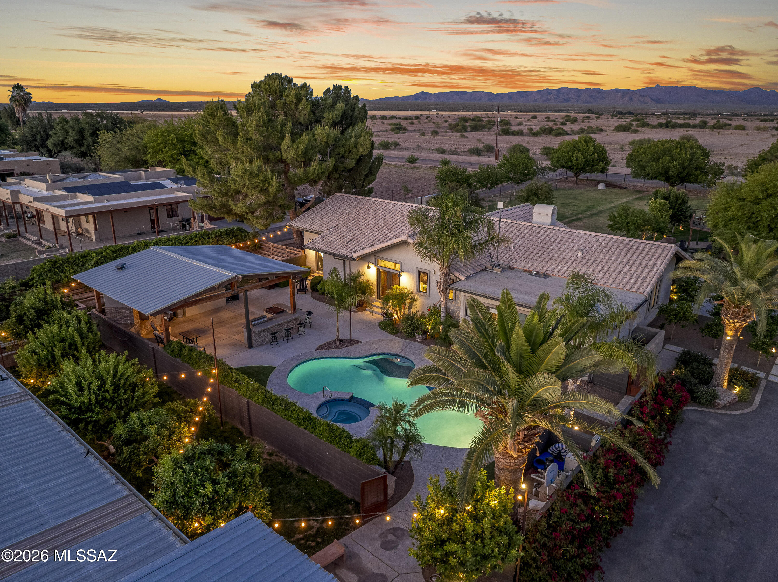 Exceptional 2.5-acre farmstead blending luxury living w/agricultural charm, featuring highly sought-after grandfathered irrigation water rights.The 3,200 sq ft farmhouse offers 4 BD & 3.5 BA, highlighted by a stunning new Negresco satin granite island. The backyard showcases a newly plastered pool, built-in BBQ, & pavilion, perfect for relaxing or entertaining.
The property includes a 5+-car garage often used as a private wedding & event venue, including hosting the ''Marana Market.'' Equestrian & farm amenities abound w/multiple barns, saddle & tool storage, a covered RV carport, RV septic hookups, and three 200-amp power panels.Multiple horse pens w/water & mare motel. 3 lush pastures, mini-orchard, mature gardens, mini vineyard & over 100 fruit & nut trees. Goat pens w/milking barn & . a chicken coop, pig stall, & donkey pens w/shade. Enjoy a pond, custom playhouse w/AC unit, huge front patio w/fireplace. Ideal for a private farm, ranch and weddings. 
Seller has also added an additional 2940 sqft of asphalt and 6340 sq ft of concrete to the property areas. The main shop has a sewer connection, and 220 electricity with a 200-amp panel. 
See additional attachments for more upgrades this property offers.