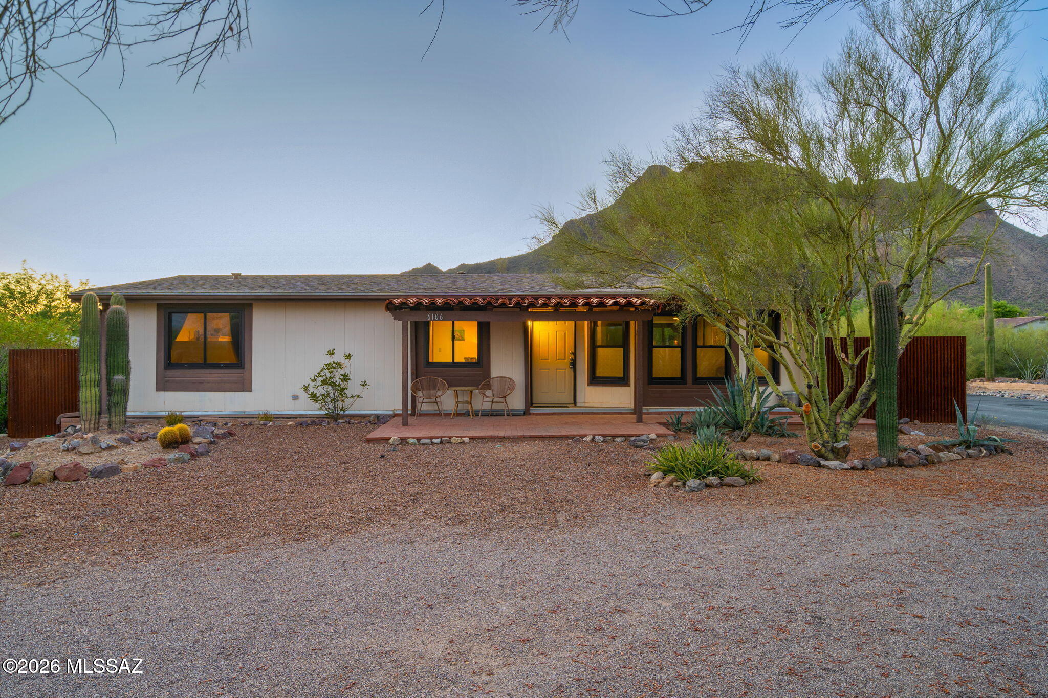 Beautifully updated 2-bedroom, 2-bath manufactured home located in Tucson Estates No. 2. This 1,352 sq ft residence features an open floor plan with abundant natural light, thanks to large windows throughout. The upgraded kitchen boasts wooden cabinetry and a modern, larger sink, all enhanced by luxury vinyl plank flooring (no carpet!). Transform your creative ideas into reality in your private studio.
Enjoy stunning mountain views from both the Arizona room and the outdoor patio. The spacious lot includes a circular parking area for guests at the front, while a new rustic metal fence surrounds the backyard, providing privacy and character. This corner lot offers plenty of space, low-maintenance desert landscaping, and breathtaking views. HOA amenities include a clubhouse, pool, tennis courts, pickleball, and golf facilities. The home features forced-air heating, central air conditioning, and natural gas utilities.