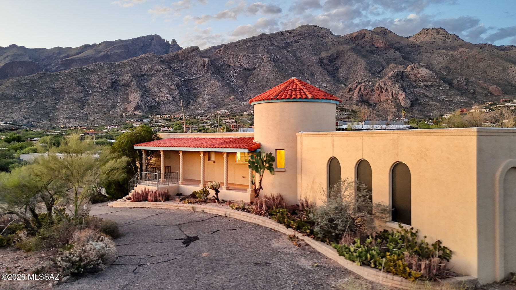 High on a hilltop in Tucson's Catalina Foothills, this distinctive all-masonry stucco home was built by renowned Tucson builder Dale Chastain and is located in the sought-after Coronado Foothills Estates. Situated on a .868-acre lot with Finger Rock as a dramatic backdrop, the home captures sweeping city and mountain views and is within the acclaimed Catalina Foothills School District.  Offering 2,815 square feet, the residence features 3 bedrooms, 2½ baths, and a 2-car garage. An expansive front porch provides the perfect setting to relax and enjoy spectacular sunsets and sparkling city lights. Inside, the impressive foyer is a soaring circular turret highlighted by a graceful spiral staircase leading to upper bookshelves and clerestory windows that fill the space with natural light. Ready for your creative vision, this home offers an exceptional opportunity to remodel, update, and design the home of your dreams. The grand 29' x 15' living room showcases a dramatic beamed ceiling, while the formal dining room could easily be reimagined as a spacious family room. The generous kitchen and adjoining breakfast area provide an ideal canvas for today's open-concept living and your own designer touches.Step outside to enjoy your private swimming pool, surrounded by the beauty of the Catalina Foothills. Just minutes from Skyline Country Club, La Encantada, fine dining, and premier shopping, this property combines an outstanding location with tremendous potential. With the right updates, this home could truly become a showpiece. Come experience the possibilities for yourself.