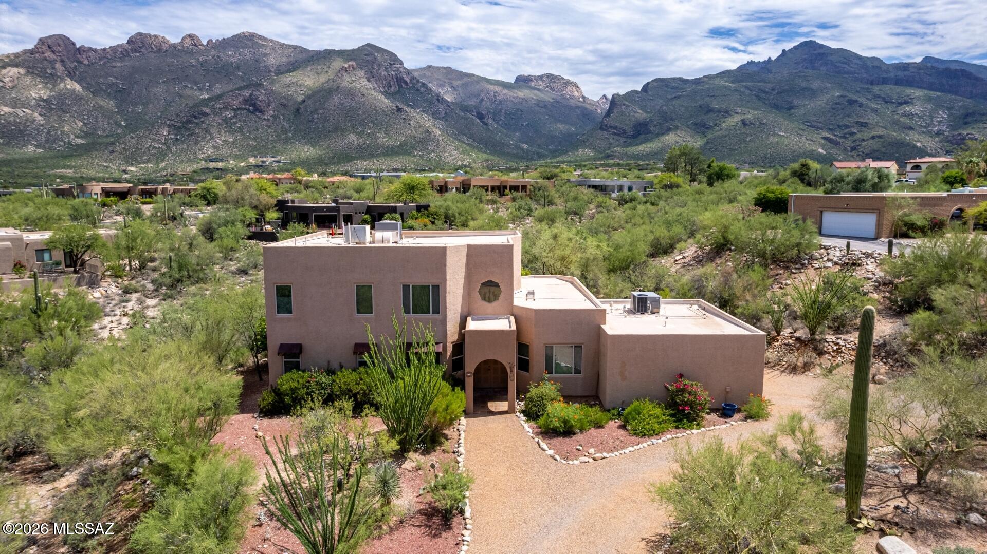 This 3-bedroom, 2-bath home with a 2-car garage, low-maintenance desert landscaping, mountain views. The open living room features vaulted ceilings, abundant natural light, and wood-look flooring. A separate family room with a two-way fireplace offers additional living space, while the formal dining room is ideal for entertaining. The kitchen includes solid surface countertops, Saltillo tile flooring, built-in appliances, and a hanging pot rack. Upstairs, the loft provides flexible space for an office or second living area. Conveniently located near shopping, dining, parks, schools, and easy access to I-10, making commuting around Tucson simple. The primary bedroom boasts a romantic fireplace, a private balcony for taking in the panoramic views, an ensuite with double vessel sinks, and a walk-in closet. Enjoy peaceful afternoons in the backyard, which offers a spacious patio and stylish pavers. Don't miss out on this incredible gem!