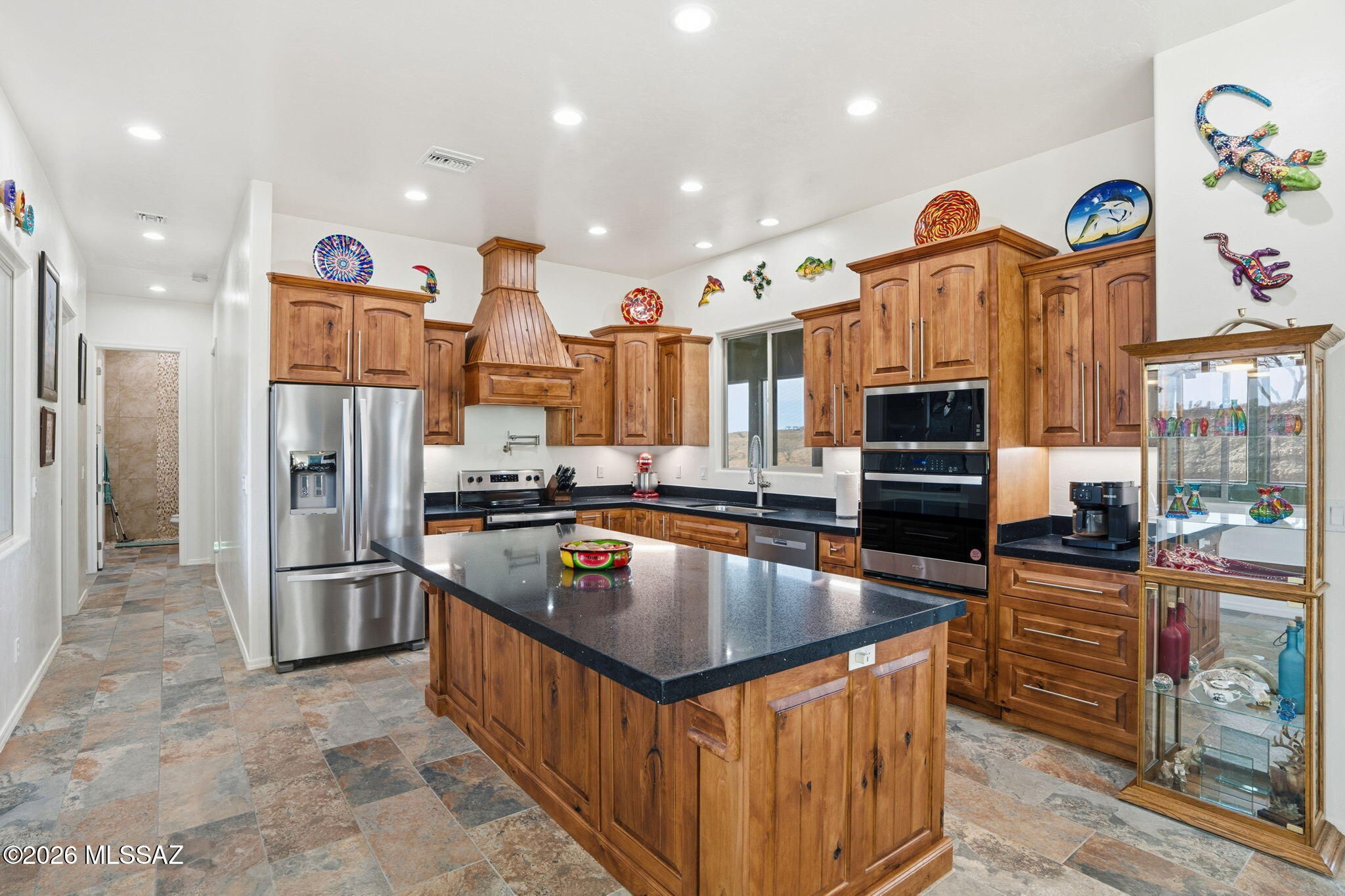 This Santa Fe gem is fully furnished and located in the picturesque Patagonia Lake Ranch Estates. It is now available! The property boasts stunning mountain views across more than 11 acres. In your private arroyo, you will find an abundance of firewood. The area is ideal for horseback riding, dog walking, and ATV adventures. Designed with 100% handicap accessibility, the property does not compromise on designer finishes. It features slate-like flooring, vessel sinks, exceptional craftsmanship, and a fully paid-for 39-panel Solar System. Each window and door is placed with care, from the front sunroom to the rear pet suite. The suite is equipped with Meshtec screen protection for your cherished pets. Additionally, there is an oversized garage to accommodate your beloved truck. The indoor hot tub offers a perfect setting for enjoying Arizona sunsets. Need a Casita?  The pre-wiring and pre-plumbing are already in place. Located just minutes from the lake with year-round recreational activities, this property provides convenient access to Patagonia, Sonoita, and Nogales. It is a must-see!