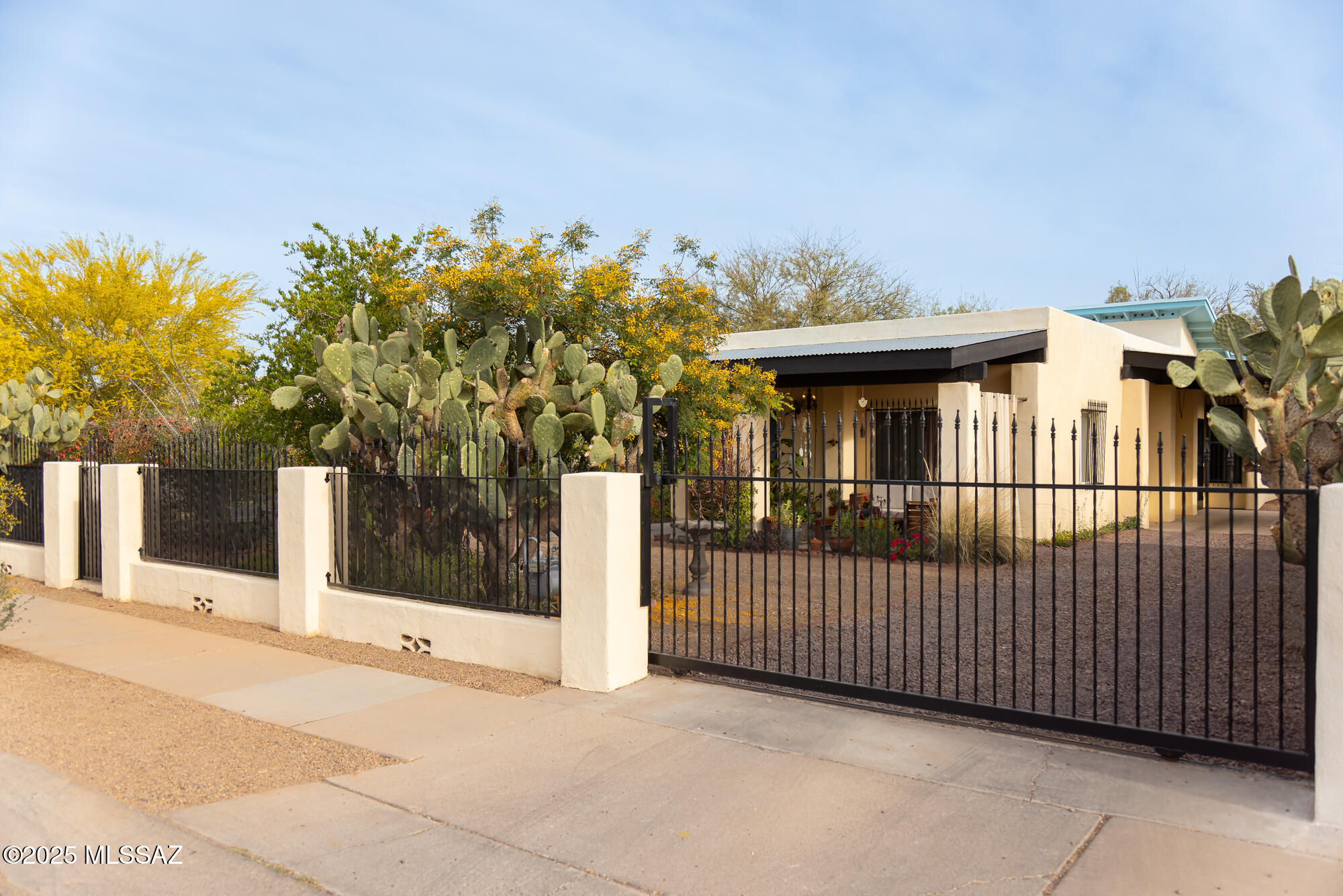 Welcome to your desert oasis! This 3-bedroom, 2-bath home offers the best of both worlds. Peaceful garden living just minutes from hiking trails at Saguaro National Park, A Mountain, and Tumamoc Hill, plus quick access to downtown Tucson, the Mercado District, and popular local restaurants. Step outside to enjoy mountain and sunset views from the cozy front porch, or relax in the heirloom garden that comes back year after year. Backyard has raised vegetable beds, fruit trees, and mature desert landscaping. Whether you're growing your own food or simply enjoying the view, this outdoor space is made for Tucson living. The original 1940s Adobe was fully renovated and a large part of the sq.ft. was added in 2004. Seller has since updated the kitchen, replaced bathroom vanities, aluminum fencing, and newly re-coated the roof. The kitchen is designed with foodies in mindfeaturing a Bertazzoni gas range and hood, quartz countertops, and a hand-cut slate tile backsplash. The open layout flows easily for entertaining or everyday living. All three bedrooms offer ample space, and the primary suite opens directly to the backyard for morning coffee or evening stargazing.

Additional highlights include potential mortgage credits, ask the listing agent for details!