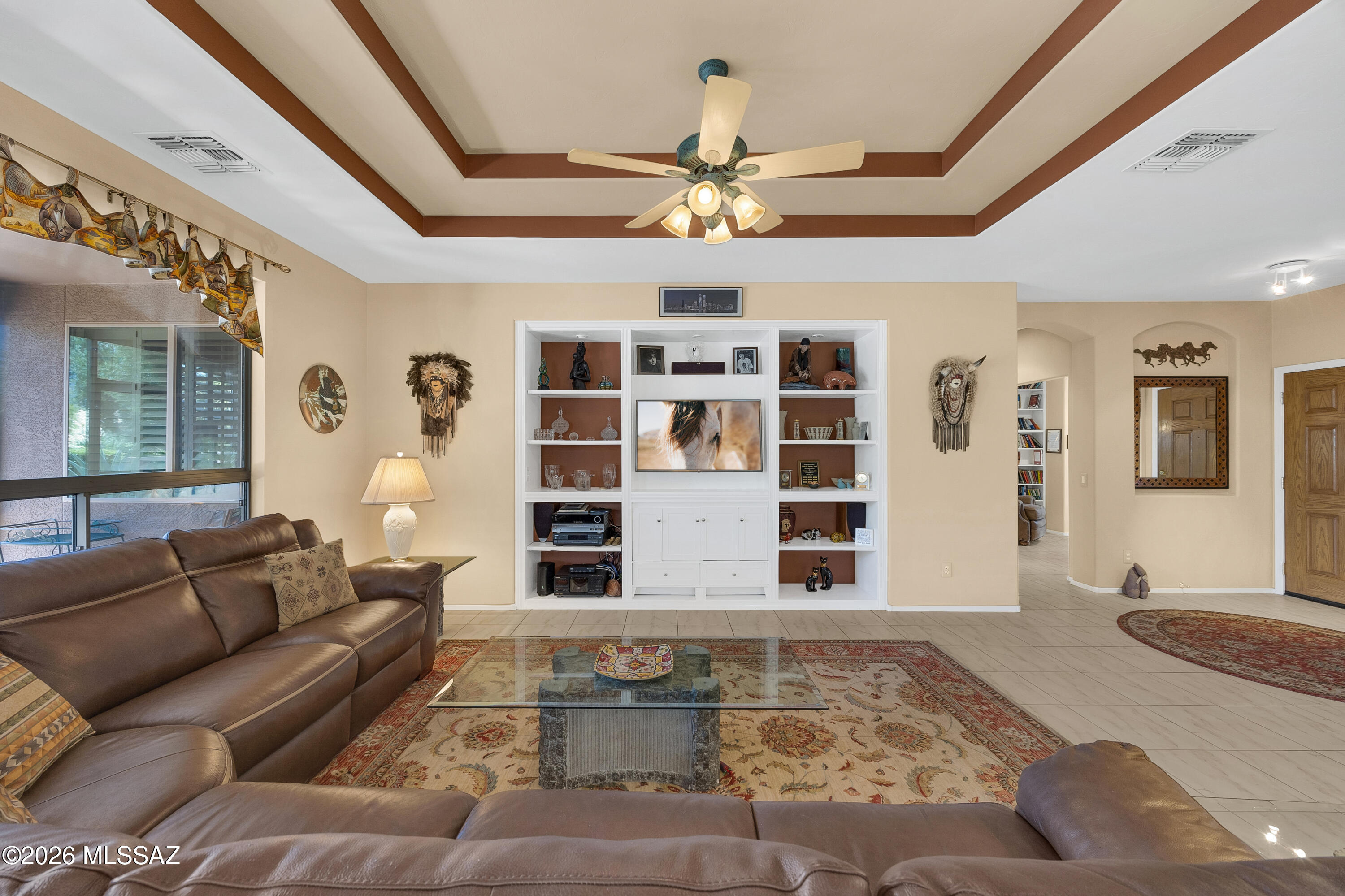 HIGH QUALITY HOME w/so many UPDATES and UPGRADES!!   Lovingly cared for, one-owner home! This Cimmaron shows like a new model and is move-in ready!  Start w/the perfect paver driveway, to the custom wrought iron storm door, to the Great Room with tray ceilings & designer shelves, to the incredible island kitchen & serene screened-in porch, it is all clean and pristine. The 3rd bedroom/office has  built-in computer desks and  book shelves. Nice views of mountain peaks from great room & kitchen!  The Primary en suite has 2 separate granite sink areas & a spacious shower plus a huge walk-in closet with custom built-in storage.  Almost everything has been replaced or updated over the years including the roof and 2 HVACs.  There is nothing to do but move in and enjoy SaddleBrooke!