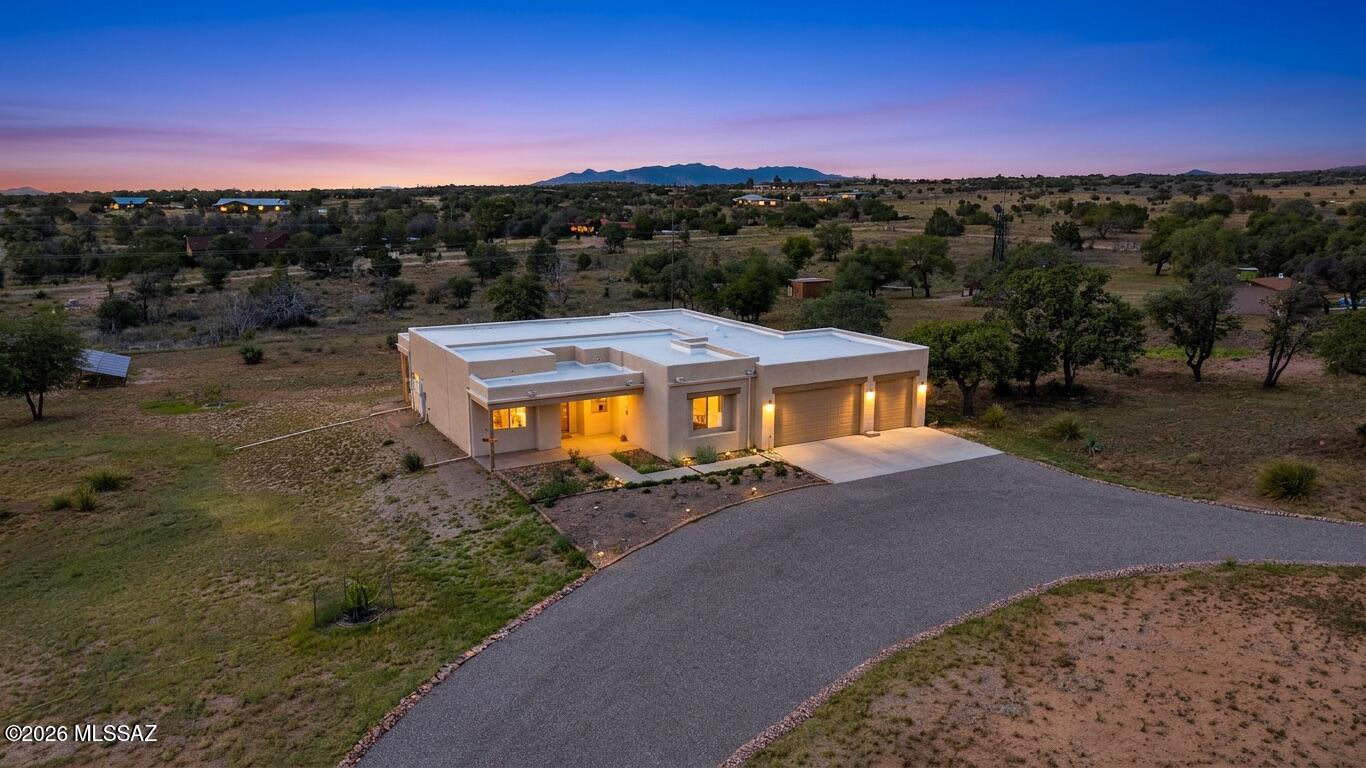 Welcome to your own private slice of Arizona paradise! Nestled on 2.27 acres in the heart of
Sonoita, this beautifully maintained 3 bedroom, 2 bath home offers breathtaking panoramic
views of the Santa Rita, Whetstone, Mustang, and Huachuca Mountains. With no immediate
neighbors, a private well providing reliable water access, and peaceful high-desert
surroundings, you'll enjoy the tranquility of country living while remaining just minutes from
local restaurants, wineries, and the renowned Sonoita rodeo grounds.
Inside, stained concrete floors create a warm, timeless foundation throughout the home. The
thoughtfully designed floor plan includes a versatile bonus room perfect for a home office,
hobby room, or reading retreat. The master ensuite includes a large walk-in shower, double sinks, water closet, and walk-in closet. Relax year-round in the inviting screened-in porch, where spectacular mountain vistas and  unforgettable Arizona sunrises become part of
everyday life. Lovingly updated by the current owner, this home features numerous improvements including a Frigidaire induction range, Bosch dishwasher, refrigerator, washer and dryer, updated ceiling fans and dining chandelier, fan wall controls, decorative kitchen and bathroom cabinet hardware, upgraded shower heads, a convenient laundry sink, pet-resistant solar screens, screened back porch, gutters with downspouts, wrapped beams, and a professionally chip-sealed driveway.
One of the property's most valuable features is the owned solar array paired with a Tesla Powerwall 3 whole-house backup battery, providing enhanced energy efficiency, peace of mind, and dependable comfort.
Whether you're searching for a full-time residence, a peaceful retreat, or an exceptional horse country escape, this remarkable Sonoita property offers the perfect blend of comfort, thoughtful upgrades and breathtaking Arizona beauty. Experience unforgettable sunrises, sunsets, star-filled night skies and panoramic mountain views from a home designed to embrace the very best of country living. Welcome Home!