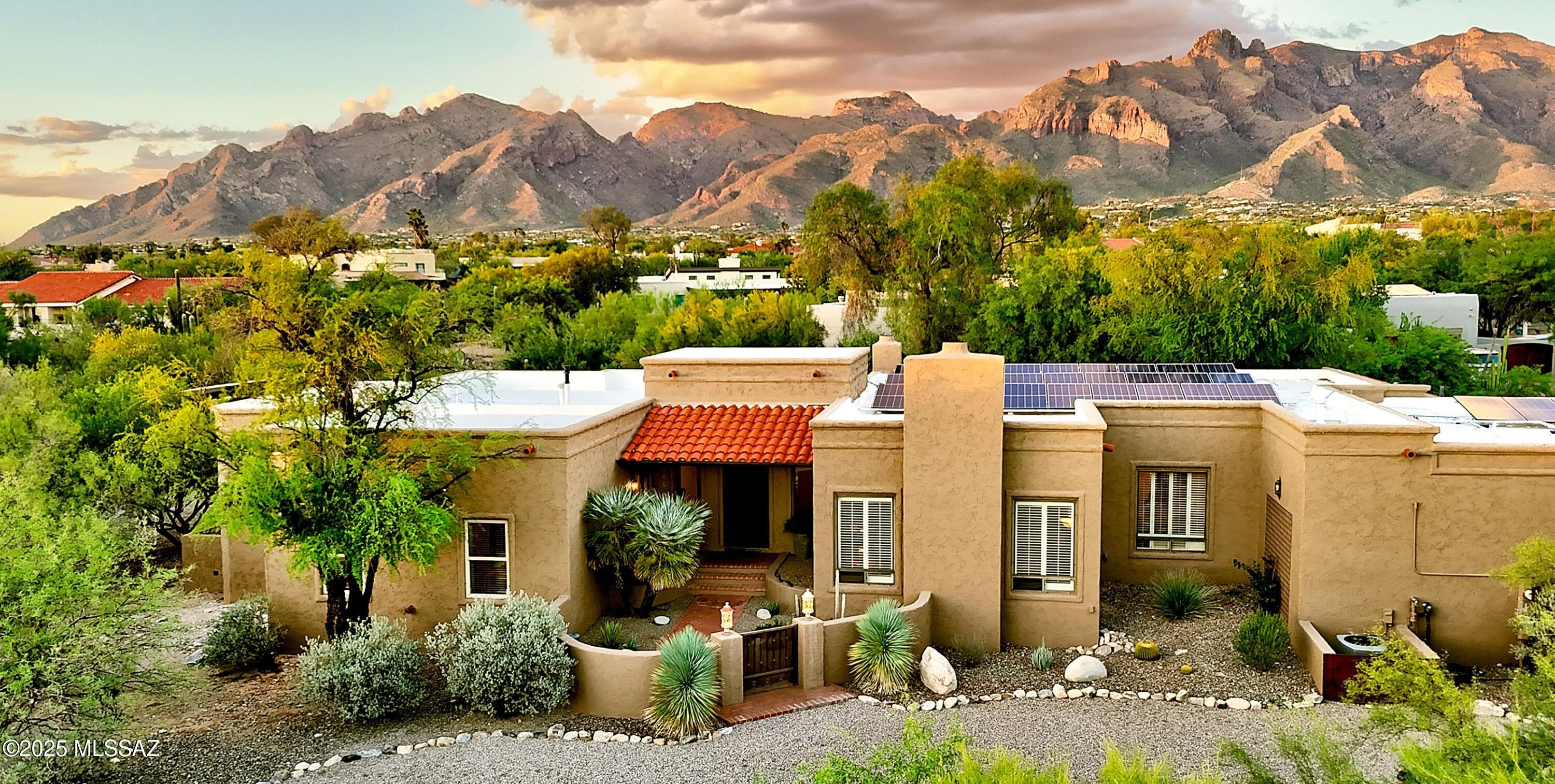 Tucked in a quiet Shadow Hills cul-de-sac, this beautifully updated designer home offers privacy, luxury, and timeless style. Step through a charming courtyard into soaring 12-ft ceilings, slate and engineered wood floors, and a grand living room with decorative fireplace. The chef's kitchen boasts stainless steel appliances, custom cabinetry and a sunny breakfast nook flowing into a spacious greatroom. French doors lead to the resort-style backyard featuring a phenomenal sparkling pool, ramada, covered patio, gorgeous turf area, and breathtaking views. The elegant primary suite includes a sitting area, stunning shower, walk-in closet and has double doors into the 4th bedroom-ideal for an office/nursery/study.  This timeless desert oasis in a premier foothills location is waiting for you.