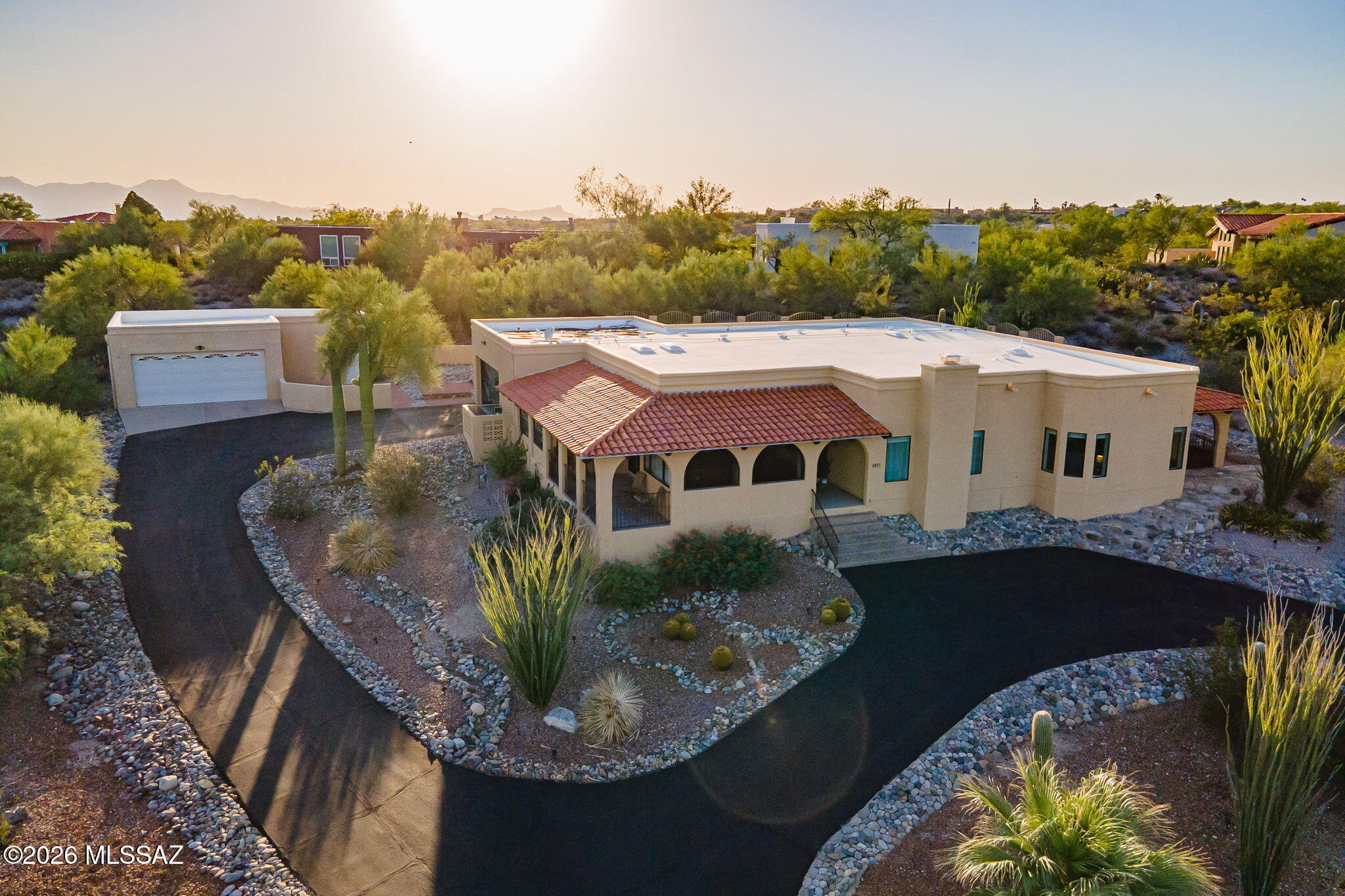 Welcome to this stunning 3-bedroom, 3-bath home offering nearly 3,000 sq ft of beautifully designed living space, complete with a 4-car garage & a backyard oasis with a pool you'll never want to leave! Enjoy incredible views with an open-concept layout. The formal living room features a cozy fireplace and elegant archways, complemented by wood-look LVP flooring & modern lighting throughout. The spacious kitchen boasts granite countertops, stainless steel appliances, a breakfast bar with seating.The bright and airy family room opens to a covered patio through a sliding door, seamlessly blending indoor and outdoor living. Retreat to the large primary suite with a private patio and a generous walk-in closet. Located in The Award-Winning Catalina Foothills School District.