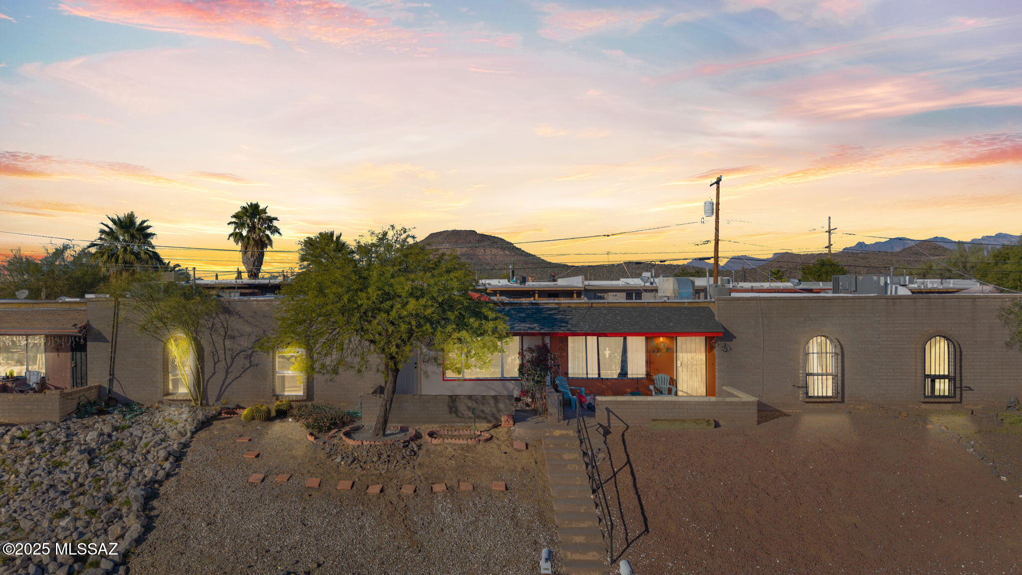 Stunning home in the desired Tucson's West side community of Enchanted Hills! This charming solid brick construction 2bed/2bath, single story, 1050sqft Townhome is truly turn-key! With an elevated lot for privacy, unrestricted VIEWS of the mountains from your gated courtyard, and NO HOA! Upon entering, this ideally designed split floor plan beauty welcomes you with big airy spaces and a bright open concept! The warm colors of the new paint and high end ceramic flooring in the foyer invite you in.. With remote controlled LED fans, double pane windows, and gorgeous views to enjoy with your family from your living room. That flows into a lovely dining area with a modern chandelier and table space thats ready for those warm dinners. That Segways into a gorgeous all new kitchen with white Cabinetry galore, SS appliances, sparkling backsplash, and a beautiful quartz countertops. With the primary featuring a double closet, tall ceilings, crisp new carpet, and Fans. The ensuite bathroom has dual sinks, matching stone counters, sleek metal fixtures, a step in marble like tile in the shower that looks like an oasis to unwind in.. Enjoy your ample covered carport with lengthwise closet offers shade and storage. With a Private and secure backyard that offers abundant space, mature trees, pavers and sunset views.. With many major upgrades such a new water heater, new metal ducts, new heating/cooling, new sewer connections/clean-outs, and new facia/roof maintenance. This prime locations has easy access to I-10, Ajo Hwy, Downtown, shopping, Pima CC, hiking/biking and so much more! Don't miss out on this GEM and make it yours TODAY!! Owner/Agent.
