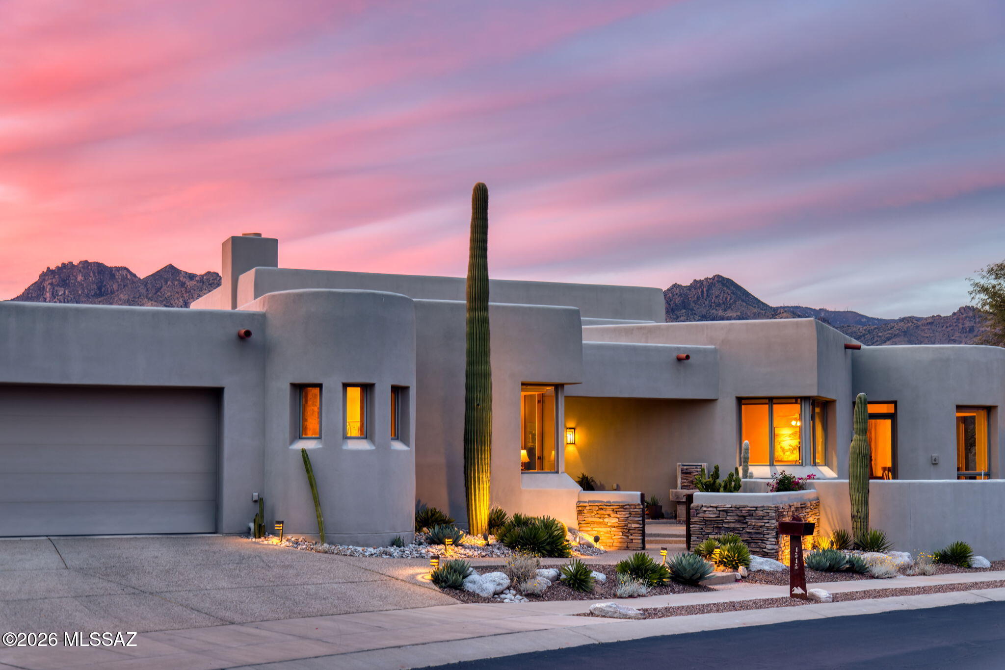 Set against a dramatic backdrop of the Catalina Mountains, this architect-designed residence by Rob Robinette in Sabino Mountain is defined by its extraordinary, unobstructed views--capturing sweeping, panoramic ranges, glowing sunsets, and distant city lights. Sited on approximately 2.8 acres, the setting is both striking and serene, offering a constant connection to Tucson's natural landscape. For those seeking true Foothills views, this setting delivers views rarely available.

Outdoor living is thoughtfully designed to embrace the scenery, anchored by a generous covered patio with misting system, built-in BBQ, fire pit, and hot tub--creating a seamless environment for both entertaining and quiet enjoyment. A front patio offers an additional vantage point with elevated valley views, while decorative lighting and water features enhance the ambiance throughout the property.

Inside, beautifully scaled interiors are filled with natural light, with large-format windows framing the surrounding vistas. Nearly every room captures spectacular views, with the great room--living and dining--defined by elevated ceilings and expansive glazing that frame the Catalina Mountains as a constant focal point. The floor plan flows effortlessly across well-proportioned living spaces, anchored by a well-appointed kitchen featuring double ovens, dual wine refrigerators, and seamless integration into the main gathering areas. A gas fireplace warms the living room, while integrated sound and automated exterior sunshades elevate everyday comfort.

The residence offers four bedrooms and three-and-a-half baths, including a flexible fourth bedroom or office with Murphy bed. The primary suite is privately positioned, offering equally spectacular mountain views, while all bedrooms feature walk-in closets. Thoughtfully integrated storage is found throughout, complemented by an oversized three-car garage with built-in workbench and substantial storage capacity.

Recent updates include three HVAC systems (recently replaced), a newer water heater, and updated interior blinds (April 2026). Additional features include whole-home water purification and softening systems, enhanced security and fire alarm systems. A pool design is available, offering future expansion potential.

Located within the gated community of Sabino Mountain Estates, residents enjoy privacy, access to scenic desert trails, Canyon Ranch, and close proximity to the Catalina Foothills' dining, shopping, and top-rated schools.