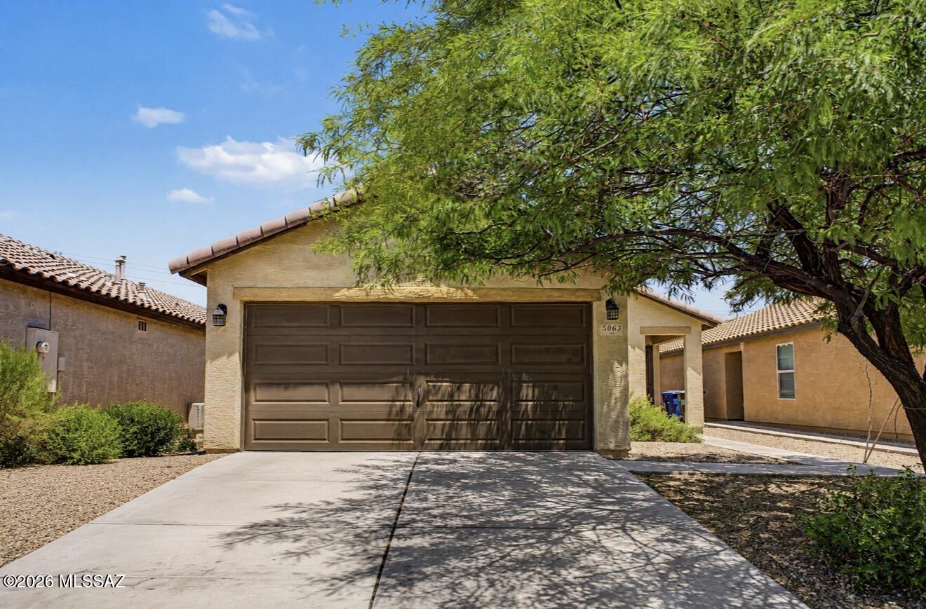 Home, sweet home! Comfort meets convenience in this charming single-level residence. Offering 3 beds, 2 baths, 2-car garage, and a mature landscape. Enter to find a desirable great room with surround sound, making entertaining a bliss! Tons of natural light, a designer palette, and carpet & tile flooring throughout are some features that can't be left unsaid. The kitchen boasts built-in appliances, a pantry, recessed lighting, ample wood cabinets, and a center island. Large main bedroom has a walk-in closet & a full bathroom w/dual sinks. Check out the backyard, where you can relax or enjoy BBQ! A covered patio, well-laid pavers, and additional open seating area complete the picture. No rear neighbors! Easy access to the I-19, and close to schools, shops, & dining options. Make this yours!