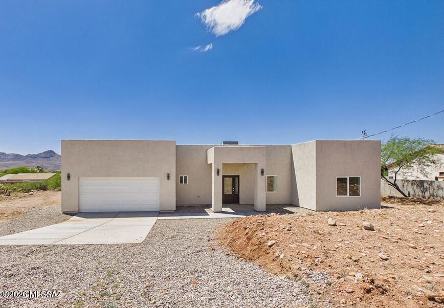 Modern finishes, thoughtful design, and plenty of room to enjoy! This beautifully crafted 3-bedroom, 2.5-bath home offers 1,701 sq. ft. of living space on an oversized 0.44-acre lot. The open-concept floor plan features a stunning custom kitchen with granite countertops, a large center island, custom cabinetry, and ample space for entertaining. The spacious primary suite includes dual closets and a beautifully designed bathroom with custom tile finishes. Throughout the home, you'll find stylish fixtures, quality craftsmanship, and elegant tilework that add character and charm. Enjoy the freedom of nearly half an acre with endless possibilities for outdoor living, gardening, RV parking, or future additions. A wonderful opportunity to own a move-in-ready home with modern touches and room to grow in beautiful Rio Rico.