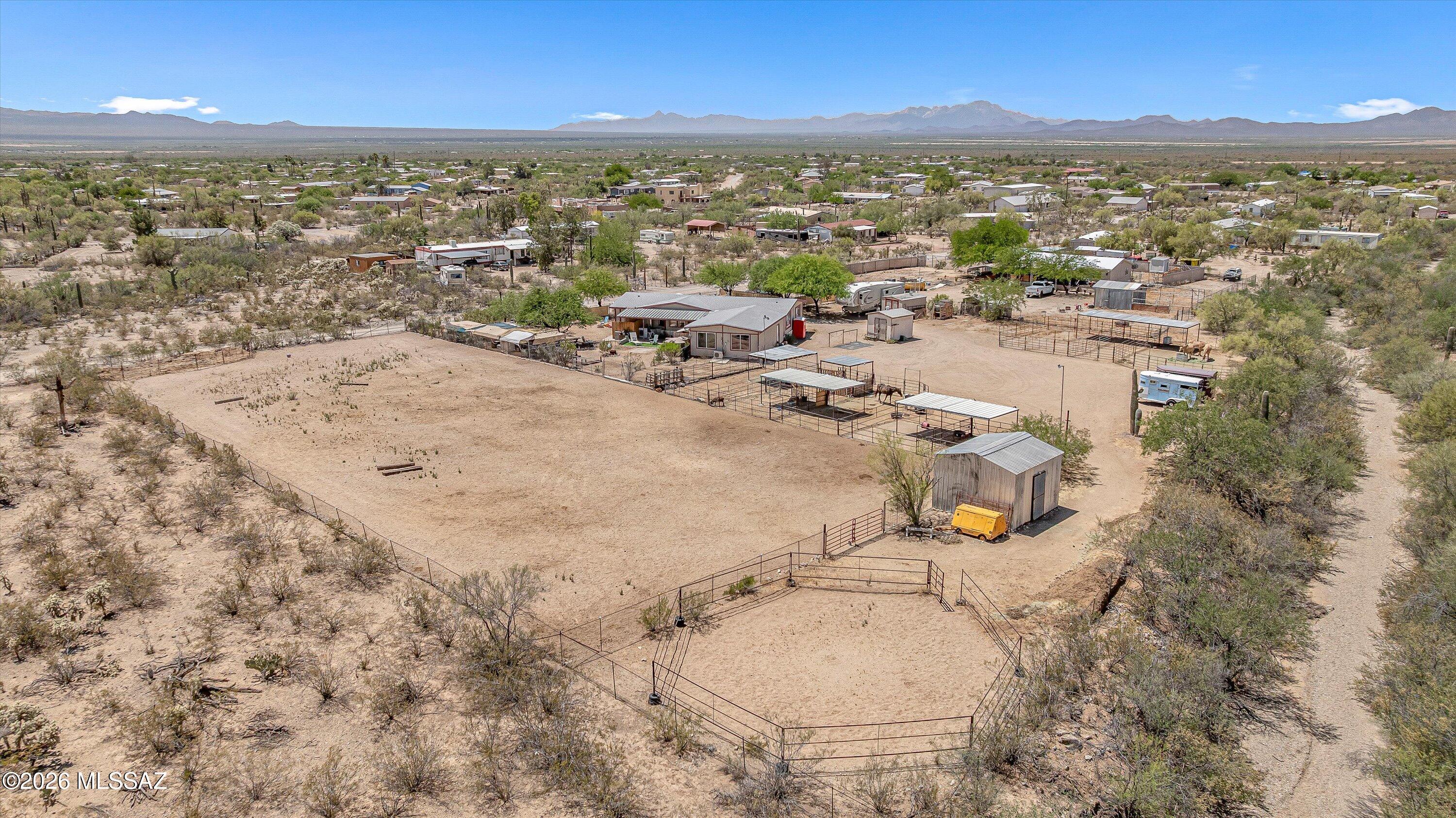Bring all your toys and the whole herd - this inviting RANCHETTE truly has it all! Set on 2 fenced acres, it's ready for country living with an arena, round pen, 9 horse stalls, hay barn, tack room, shed, and (2) RV hookups with water / 30amps, (1) full RV hookup, chicken coop, wired for a hot tub,  PLUS a charming studio that is currently rented for $650 per month. The updated 1664 sq ft home features 3 beds, 2 baths, a generous bonus room, vaulted ceilings, granite counters, and a bright, open layout. Currently a horse boarding facility, it offers income potential or room to create your dream homestead. Enjoy fenced corrals, shaded areas, a large arena, and direct access to expansive parkland - no need to trailer! Relax under the covered patio and take in sweeping mountain views!