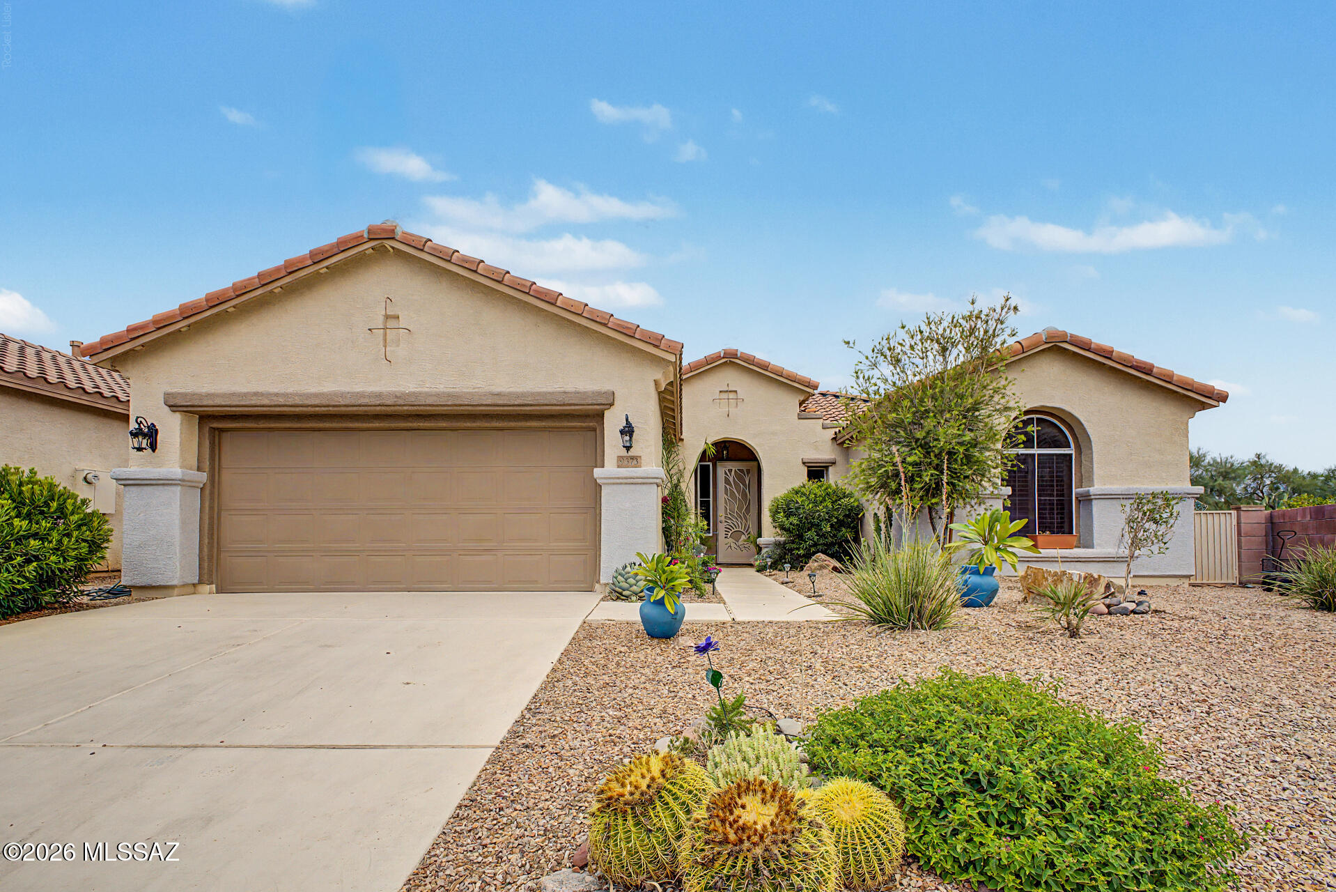 Your dream home is here! This lovely 3-bedroom property welcomes you with a 2-car garage and a low-maintenance desert landscape. Fall in love with the captivating open layout featuring wood ceilings with exposed beams for a rustic appeal, plantation shutters, a soothing palette, and wood-look flooring. The well-appointed kitchen comes with granite counters, custom shaker cabinetry, a decorative tile backsplash, stainless steel appliances, and an island with a breakfast bar for casual meals. The primary bedroom showcases an ensuite with double vessel sinks, a lavish raindrop shower, and a walk-in closet. Spend peaceful afternoons in the backyard, complete with a covered patio, perfect for dining al fresco or refreshing drinks. Make this gem yours today!