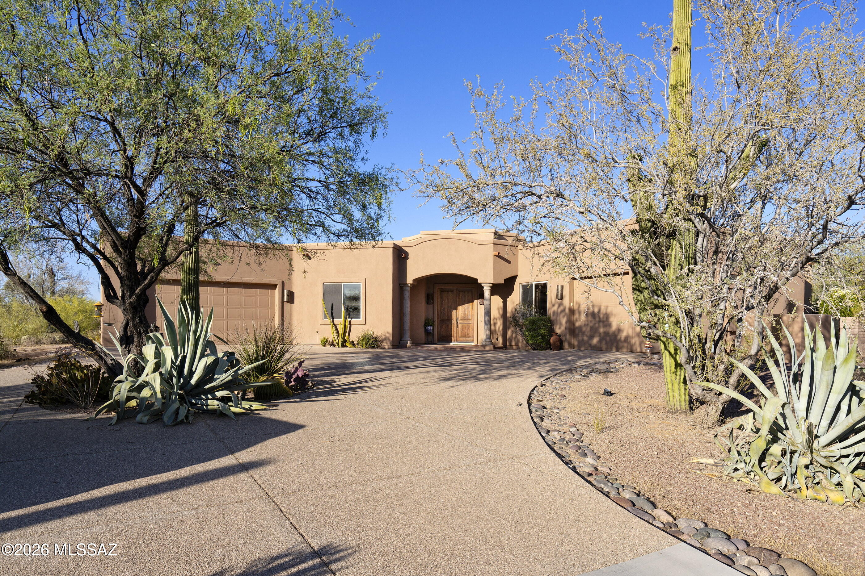 Nestled on 6.64 private acres in Oro Valley, this timeless Southwest-style estate offers stunning mountain views, exceptional privacy, & no street noise as the home sits well back from Lambert Lane. This spacious single-story, no-step home features 4 bedrooms, 4 bathrooms, plus an office w/ a thoughtfully designed split floor plan & expansive windows that fill the home w/ natural light. The chef's kitchen is designed for entertaining w/ a large island, double ovens, two sinks, a 6-burner stove, & an oversized walk-in pantry. The formal dining area is perfect for entertaining. Large primary suite offers private backyard access & a luxurious bath w/ a walk-in shower, soaking tub, & a large walk-in closet. Generously sized guest bedrooms include a Jack-&-Jill bath plus an additional en-suite. Tons of storage throughout. The resort-style backyard features a pool, spa, outdoor kitchen, & fireplace surrounded by stunning desert scenery. NO HOA. Included in the sale is the adjacent lot, bringing the total acreage to 6.64 acres. This one truly has it all!  One of the Sellers is licensed to sell real estate in Arizona.