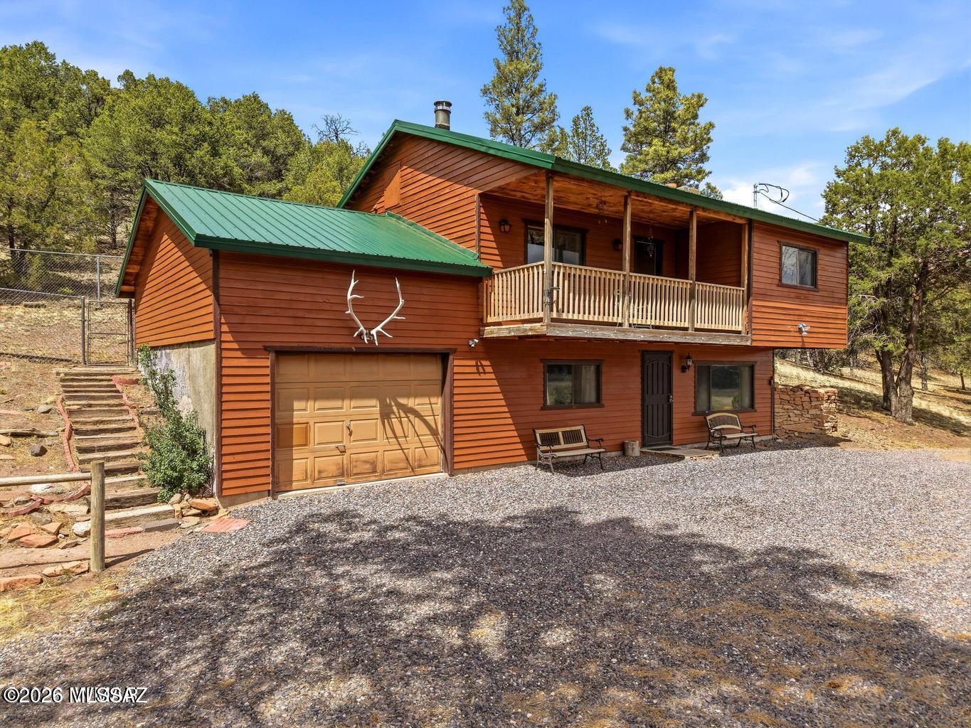 Peaceful mountain living with panoramic views overlooking Dry Valley! This beautiful custom-built home, lovingly owned by one family since 1988, is perched on a hill in Augur Canyon and offers tranquil views of the meadow, ponds, surrounding valley, and tall pines. Situated on 2.86 acres, this charming 3-bedroom, 2-bath, two-story home offers 1,435 sq. ft. of comfortable living space, its own private well, an attached garage, and a convenient horseshoe driveway Inside, the wood stove in the living room creates a warm and inviting setting for cozy mountain evenings. The exterior has been newly painted, giving the home beautiful curb appeal while preserving its classic White Mountains charm. Bring your horses and enjoy the extra space, privacy, and small outbuilding, perfect for storage, tools, or horse equipment.
This property is all about peaceful serenity, beautiful views, and the quiet mountain lifestyle. Located in Nutrioso, between Springerville and Alpine, you are surrounded by everything the White Mountains are known for, including world-class hunting, fishing, hiking, biking, lakes, rivers, streams, and abundant wildlife. Sunrise Ski Resort is approximately 30 minutes away and offers year-round entertainment for all ages. A perfect full-time residence, mountain getaway, or peaceful retreat in one of Arizona's most beautiful high-country settings.