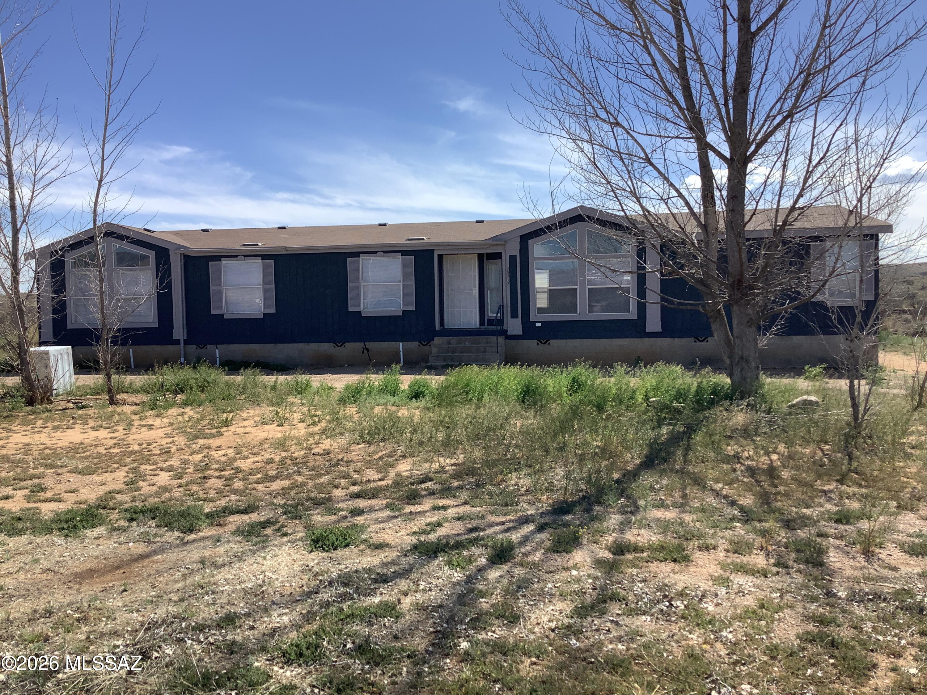 Recently remodeled home with new LVP flooring, new paint inside and out.  Built in china cabinet in dining room and entertainment wall in family room. MFH sits on block stem wall with concrete steps. Beautiful mountain views, not farm from South East entrance of the Eureka Springs Ranch.  Partly fenced around the home, nice size shed, and chicken coop area.  Land is still being cleaned up but will be completed by close of escrow.