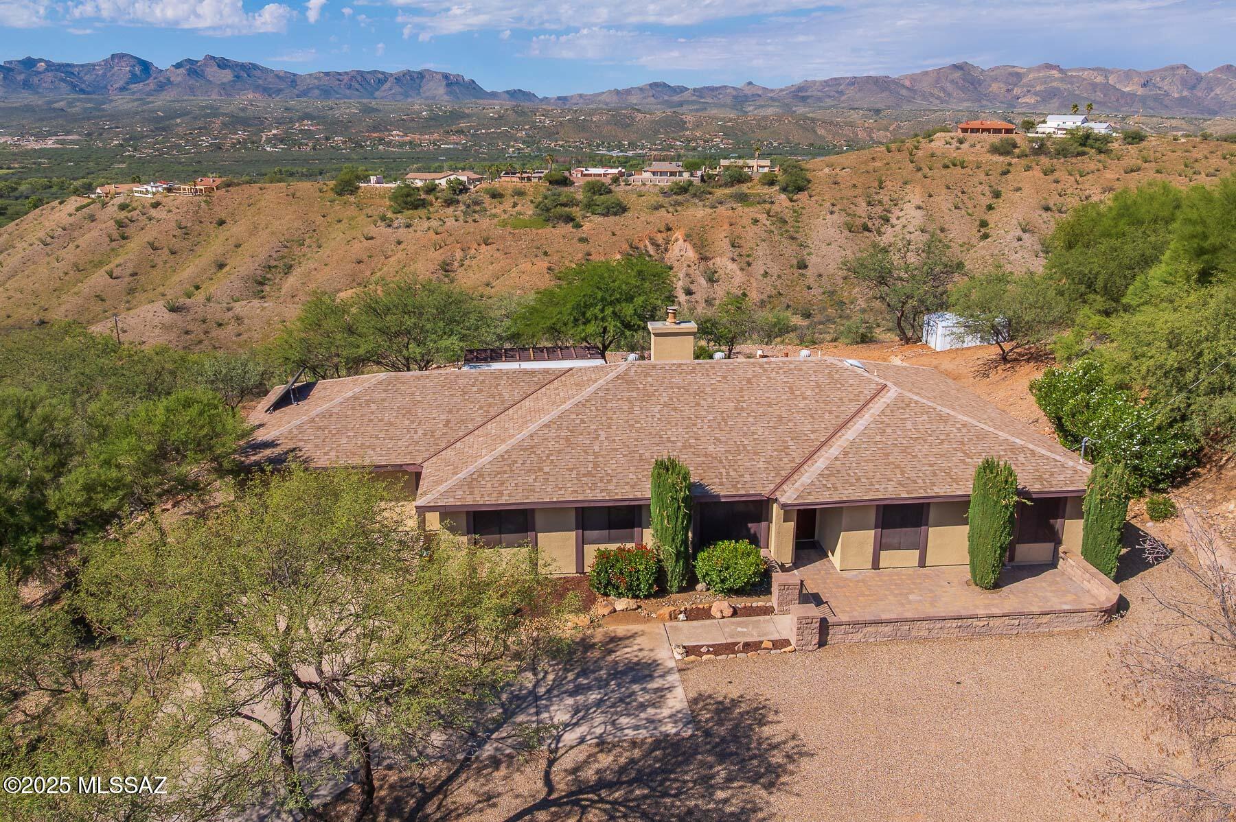 Perched on a hilltop in desirable Rio Rico, this spacious 2,603 sq ft home offers panoramic views and room to live, work, and entertain. Featuring 4 bedrooms and 3 bathrooms, this move-in ready property shines with brand-new flooring throughout and fresh interior paint, giving it a clean, modern feel.

The open and inviting layout is filled with natural light and showcases the stunning views from multiple vantage points. A huge bonus room provides endless possibilities--perfect for a home theater, game room, office, gym.

Enjoy peaceful living with breathtaking scenery, ample space, and thoughtful updates already completed. This hilltop gem is ready for its next owner to move in and make it home.