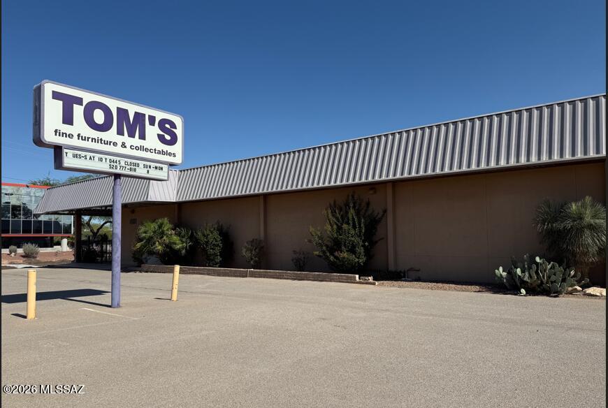 A free-standing, 9,894 square-foot, strategically-located building recognized as the longtime home of the vintage retailer Tom's Fine Furniture and Collectibles!  Recent improvements include: Entire NEW roof installed within the last three months for $25K; 2 newer HVAC units; Newly repaved front parking area; new store sign with LED lighting; new wrought iron fence & gate; new front doors; rolling shutters installed; entire exterior painted by Paint Kings.  47 parking spaces!  The entire building has fire sprinklers.  The rear fenced yard has ample parking.  The upstairs mezzanine can be used for office space or storage, and there is a lift up to the mezzanine deck.  New kitchen cabinets, a new sink, & a new  refrigerator & dishwasher!  See Documents for more property information. See More City of Tucson says that the current Grant Road construction happening in front of the store should be completed by the end of August, early September, 2026. A private, registered well exists on the property.  Contact LA's for information.
