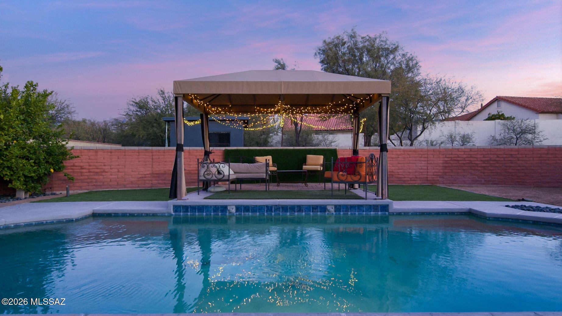Nestled in the established and highly sought-after Sabino Vista community, this inviting residence beautifully blends character, flexibility, and true Tucson outdoor living. Set on a generous .37-acre lot, the property offers an exceptional sense of space and privacy. A spacious courtyard entry, thoughtfully designed as an ''outdoor living room'' and dining area with pavers, sets the tone for relaxed desert living and unforgettable gatherings beneath the Arizona sky. Inside, a welcoming foyer and rich hardwood flooring, create warmth and continuity throughout the main living areas. Designed with versatility in mind, the ideal split-bedroom floor plan features an expansive private wing perfect for multigenerational living or extended guests, complete with its own bedroom, bathroom, spacious living room, full kitchen, and pantry offering independence without sacrificing connection.
At the heart of the home, the well-appointed kitchen with Cherry cabinetry, gorgeous green gemstone-looking granite slab counters and a sink to match, stainless steel appliances, and a breakfast bar that opens seamlessly to the family room, anchored by a cozy fireplace and a picture window that frames the backyard. A private dining area and an additional living room with French doors provide effortless indoor-outdoor flow, inviting natural light, and easy access to the outdoor retreat. The secondary bedrooms are thoughtfully positioned on the opposite wing, providing generous proportions and a natural sense of privacy for everyday living.
Outdoors, the oversized north-facing backyard captures the essence of Tucson's year-round lifestyle. A refreshing, thoughtfully designed pool serves as the sparkling centerpiece of the backyard, beautifully enjoyed from the full-width covered patio or the charming, softly illuminated gazebo. Multiple inviting spaces for outdoor cooking, dining, and relaxed lounging create effortless flow for gatherings of any size, while a discreet wire spanning the pool is ready to transform the space into an open-air theater for impromptu movie nights under the stars. Every detail of this inviting retreat has been curated to inspire memorable entertaining or quiet evenings soaking in Tucson's vibrant sunsets and breathtaking, star-filled skies. With the Catalina Mountains as a backdrop and no power lines in sight, the setting feels both serene and expansive... Ideally located just moments from Sabino Canyon Recreation Area, world-class hiking and biking trails, as well as popular restaurants and convenient shopping, this Sabino Vista residence offers not only a beautiful home.