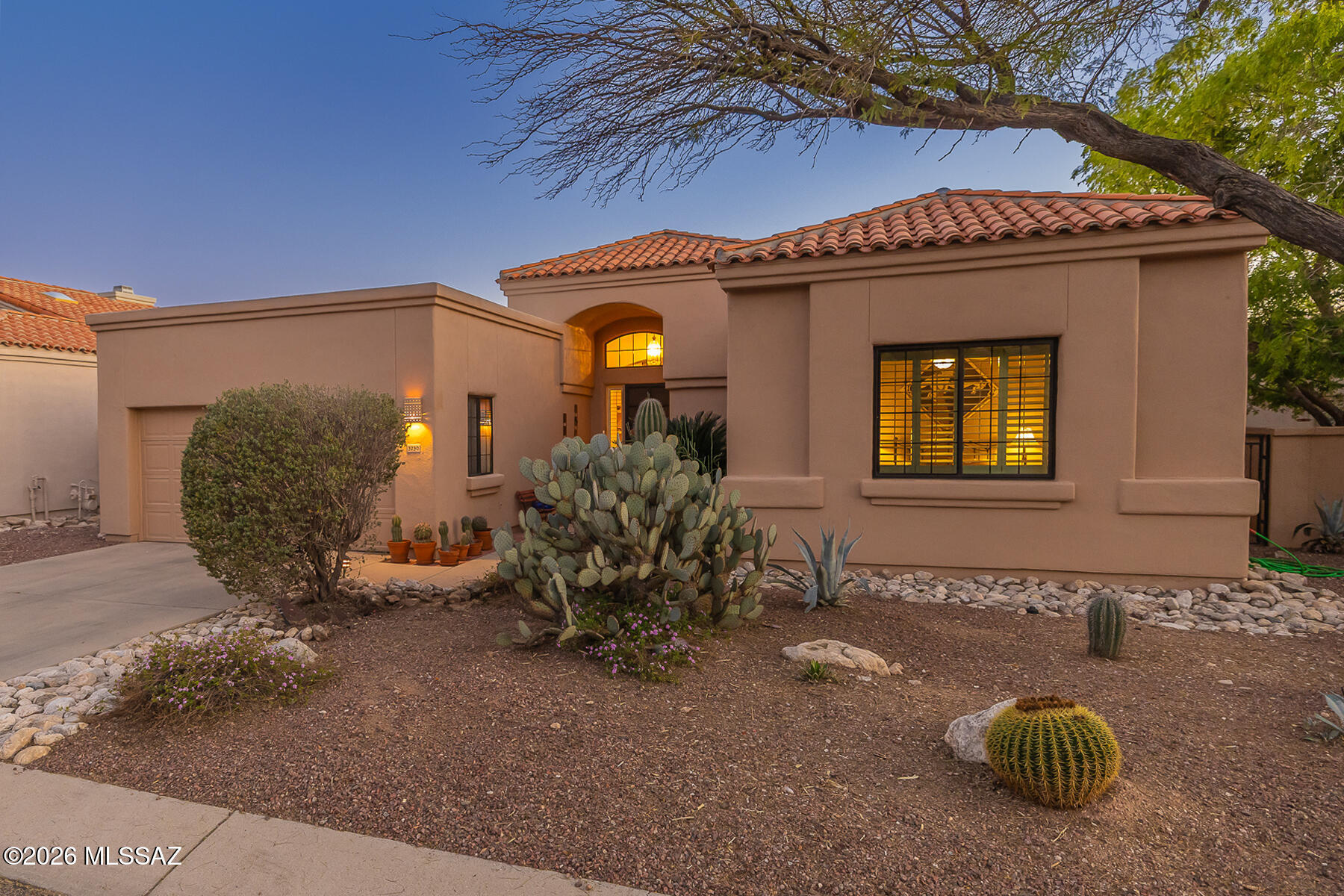 Located in the Paloma Encanto enclave within the gated La Paloma community, this elegant 3 bed, 3 bath patio home offers 2,124 sq ft of comfortable Catalina Foothills living. A welcoming entry opens to a light-filled living room with soaring ceilings, fireplace, and built-ins. The spacious kitchen features granite countertops, ample cabinetry, and a center island with bar seating, connecting to both casual and formal dining areas. The primary suite offers a spa-style bath with soaking tub, walk-in shower, dual vanities, and walk-in closet. Two additional bedrooms provide flexible space for guests, office, or den. Enjoy outdoor living on the covered patio with built-in BBQ and mature desert landscaping. Located within the gated La Paloma community near golf, dining, and shopping.