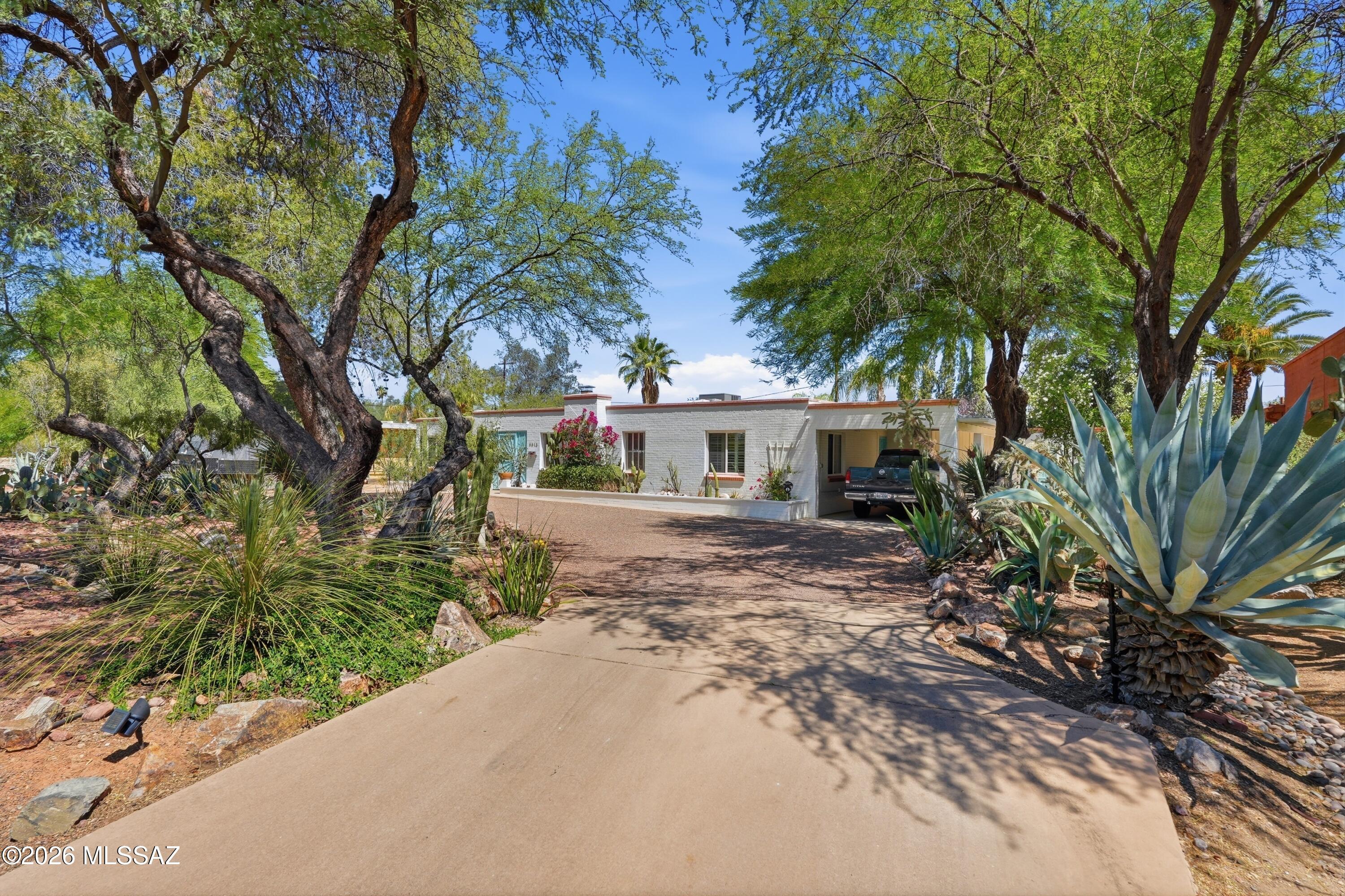 Historic El Montevideo Estates territorial with sought-after guest house in the heart of central Tucson! Rare opportunity to enjoy classic Southwest charm, mountain views, and flexible guest quarters ideal for extended family, visitors, studio, or home office. Historic tax designation adds value and character. Beautiful mature landscaping creates exceptional privacy and a peaceful setting with the quaint elegance of old Tucson. Enjoy indoor-outdoor living with pool, hot tub, and covered ramada. No HOA. Conveniently located near shopping, dining, Randolph Park, the zoo, U of A, downtown, and Tucson's vibrant cultural amenities.