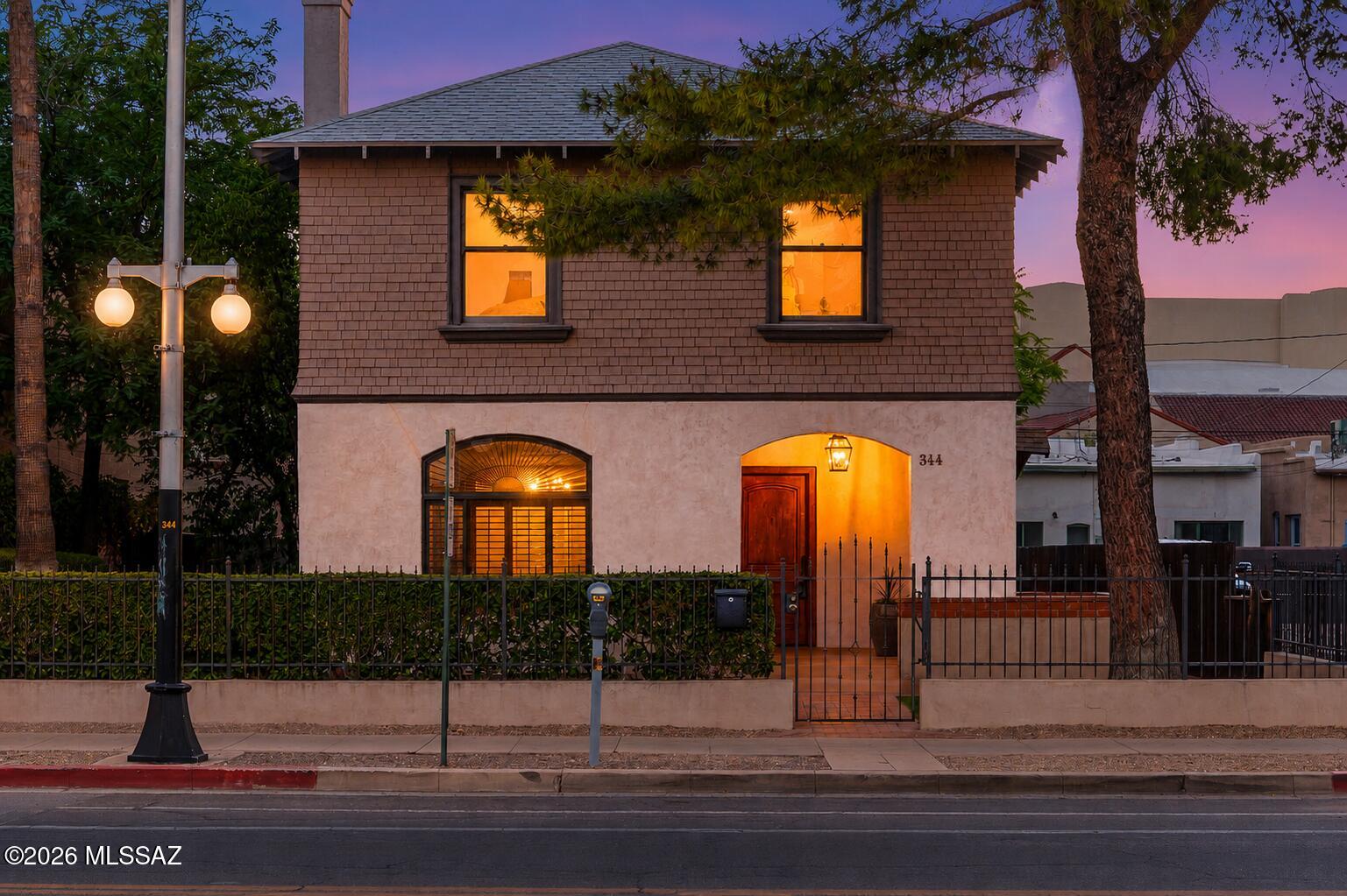 Some homes simply have walls and a roof. Others have a STORY!
Welcome to one of downtown Tucson's enduring treasures, where historic architecture, timeless craftsmanship and an unbeatable urban lifestyle come together along iconic South 6th Avenue! Lovingly cared for over the years, this beautiful two-story residence captures everything people love about Tucson's historic homes - warmth, authenticity and a character that simply can't be recreated!
Step onto the welcoming front porch and you immediately feel invited to slow down. Inside, original hardwood floors, graceful archways, rich architectural details and a classic brick fireplace create spaces that feel both elegant and effortlessly comfortable! Sunlight fills the home throughout the day, highlighting the craftsmanship and thoughtful care that have preserved its charm for generations.
The beauty of this home isn't just found inside - it's in the lifestyle that surrounds it!
Wake up and walk to your favorite neighborhood coffee shop. Spend Saturday mornings exploring the Downtown Farmers Market. Meet friends for dinner at Five Points. Pick up steaks from Forbes Meat Company for an evening on the patio. Wander through local galleries during Downtown Art Walks, visit Children's Museum Tucson with family, catch live music, enjoy festivals throughout the year or simply stroll the tree-lined streets that have made Armory Park one of Tucson's most beloved historic neighborhoods!
And when it's time to venture farther, you're only minutes from the streetcar, Mercado District, the University of Arizona, Interstate 10 and everything that makes downtown Tucson one of Arizona's most vibrant places to live!
Back home, quiet evenings on the covered balcony and private outdoor spaces offer a welcome retreat from the city's energy. This is a rare balance of connection and tranquility that makes this property truly special!
Historic homes are rarely about perfection. They're about personality. They're about craftsmanship you can see and feel. They're about becoming part of a neighborhood with roots, culture and a sense of place!
If you've been waiting for a home that offers more than just a place to live--one that invites you to become part of Tucson's story, then 344 S. 6th Avenue is ready to welcome you home!!!