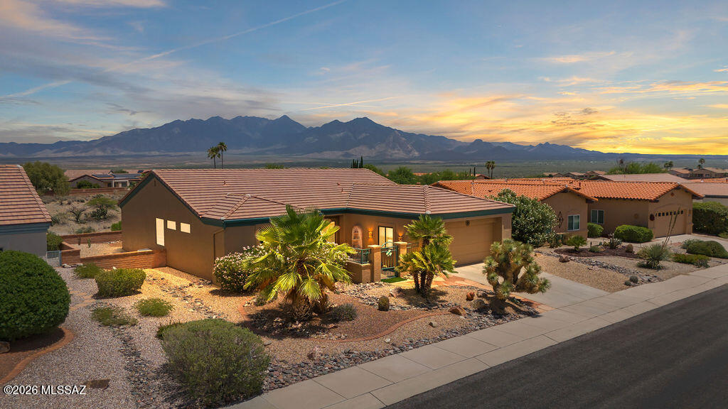 Breathtaking Santa Rita Mountain views set the stage for this beautifully updated 2BR/2BA home offering 1,787 sq ft of comfortable Arizona living. Soaring cathedral ceilings with crown molding create an open, airy feel throughout. The remodeled kitchen features upgraded cabinetry, granite countertops, stainless steel appliances, tile backsplash, and abundant storage. Both bathrooms have been updated with matching cabinetry for modern look. Flexible living spaces include a dedicated office, separate sitting room, spacious living area, and oversized primary suite with walk-in closet. Large windows capture natural light and mountain views. Enjoy outdoor living from the covered patio surrounded by mature, low-maintenance desert landscaping.  Range Price Seller to counter $385,000 - $400,000.