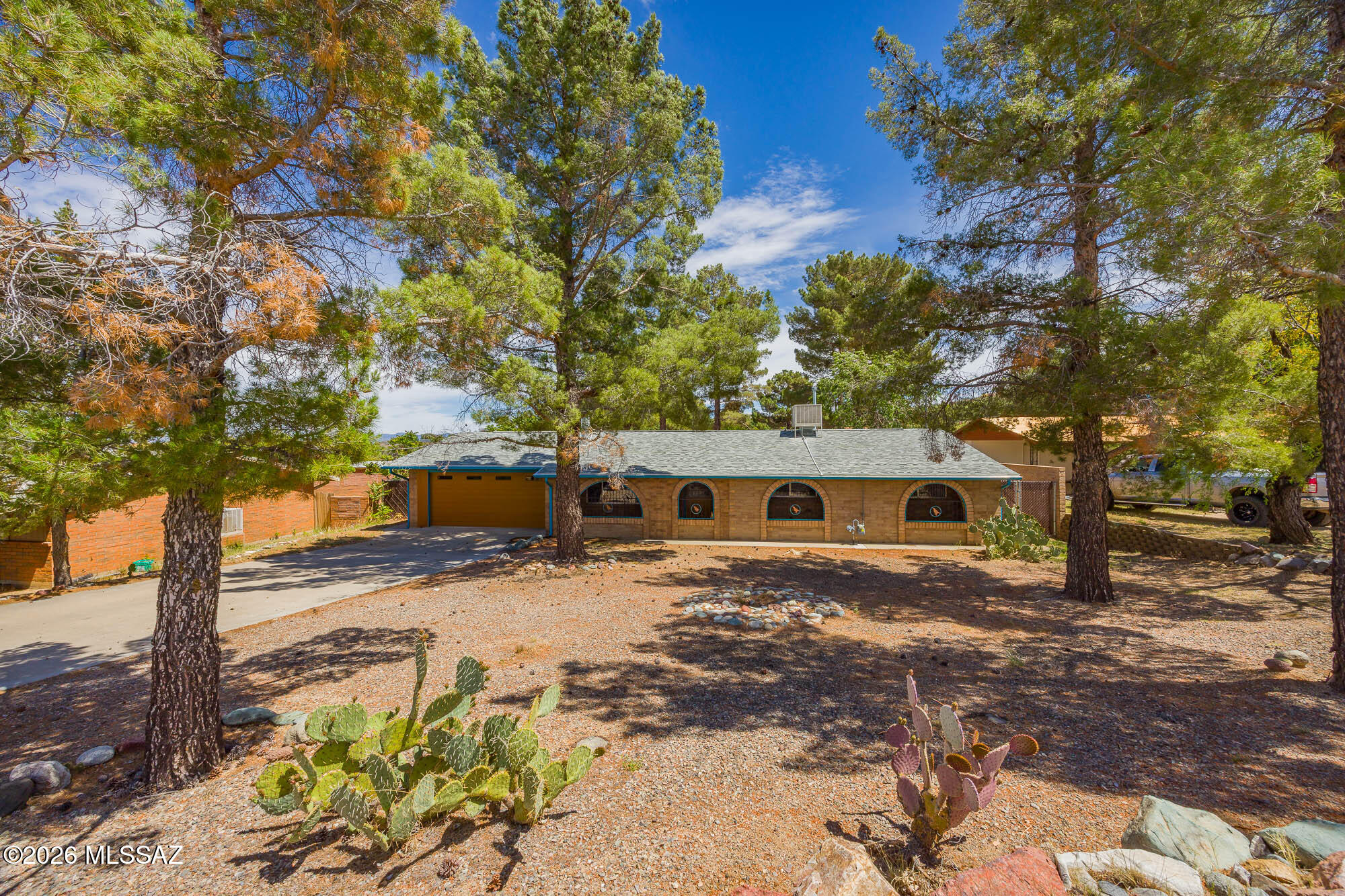 Escape the city and enjoy the cooler weather in the beautiful town of Oracle. Take advantage of the USDA loan program available outside city limits with 0% down for qualified buyers. This 3bd/2ba home features many extras including: a cozy wood burning stove; new carpet in hallway and bedrooms; extra-large laundry room w/an abundance of storage: an extra storage or hobby room: custom shelving: fresh interior paint in the majority of the home: gorgeous walk-in tiled shower in primary bath: full-length covered patio in the back looking: and a full-length enclosed porch out front. Both surrounded by mature pine trees adding to the beauty. Enjoy parking in the 2-car garage with shelving and plenty of room for storage. You don't want to miss out on this beauty!