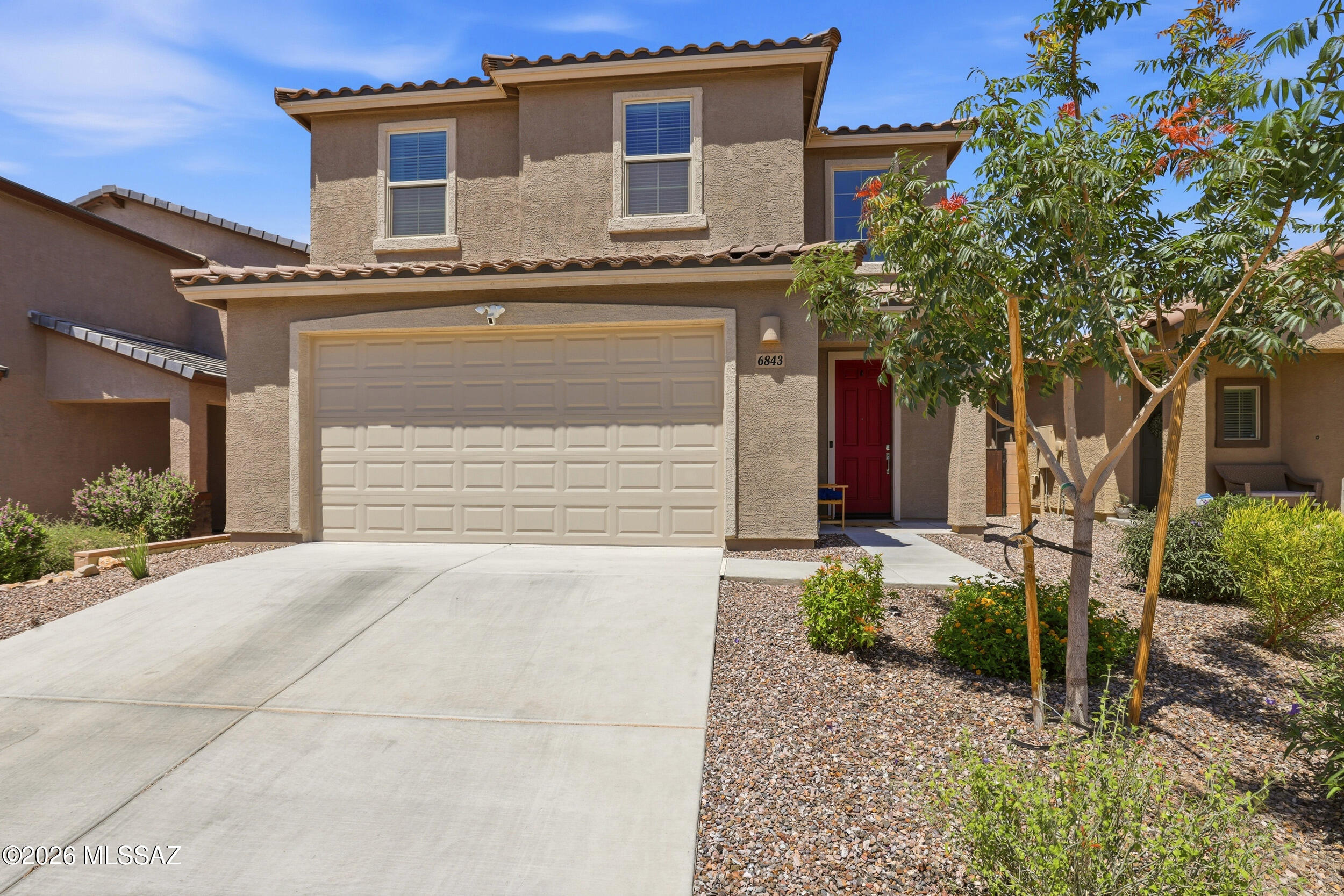 Motivated owner/agent will accept or counter offers between $410,000-$430,000. Beautiful 2024 Lennar Abbott floor plan on a premium elevated lot with no rear neighbors. Enjoy an expansive 85-foot backyard with plenty of space to play, relax, or entertain. Close distance to the community pool! Inside, high ceilings and natural light fill the home. The oversized kitchen offers abundant counter space, storage, and room to gather. Upstairs you'll find a spacious primary suite, three additional bedrooms, walk-in closets, and a loft. Added features to appreciate: granite countertops and upgraded cabinets throughout the entire home, tankless water heater, smart thermostats, built-in pest control system, and EV charging port. Located in La Estancia and the top rated Vail School District!