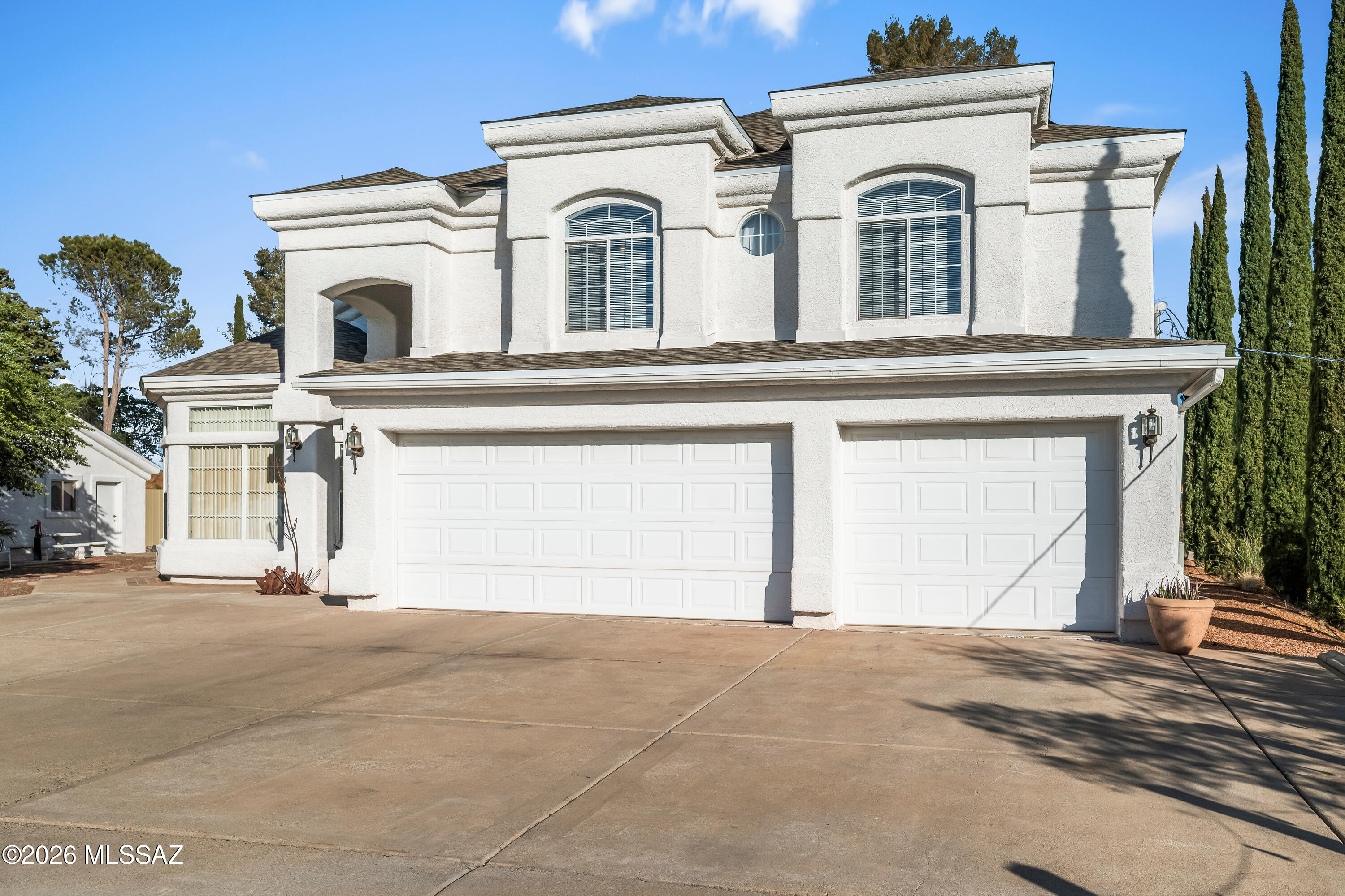 Price Improvement! Got cars, RV, boat, or toys? This rare 6-car garage property truly has room for it all--3 attached, 3 detached, plus RV parking! No HOA and situated on a half-acre hilltop lot offering panoramic mountain and city views from every window. This 2,626 sq ft home features new luxury vinyl flooring, an open kitchen with new stainless steel appliances, Corian countertops, oak cabinets with pull-out drawers, island, desk/coffee station, and updated lighting. The primary suite is downstairs with walk-in closet, dual sinks, jetted tub, and separate shower. New roof on home and detached garage (10/2024), newer main AC, low utility costs, and exceptional privacy. A rare, versatile property you won't want to miss! See Video. Property qualifies for USDA loan. Conveniently located near Oro Valley. Appealing location close to major state and government employment centers in Florence.