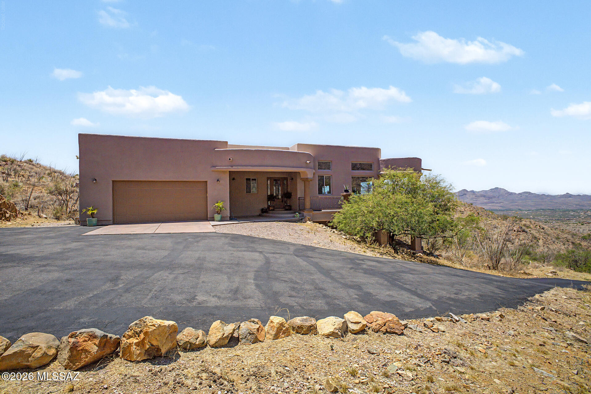 Perched high above the valley, this exceptional 3,456 sq. ft. custom home offers breathtaking panoramic views stretching across Rio Rico, Sahuarita, and the surrounding mountain ranges. Meticulously maintained and being sold fully furnished, this one-of-a-kind property combines luxury, comfort, and timeless design in an unforgettable setting.

The heart of the home is an expansive great room designed for both relaxation and entertaining. Elegant finishes and walls of windows that frame the stunning desert landscape. The spacious kitchen is equipped with GE Profile black stainless appliances, beautiful hickory cabinetry, and a generous walk-in pantry.


Home is being sold fully furnished. See more section & attached documents for details Step outside onto the impressive 1,200 sq. ft. wraparound deck, where you'll enjoy unforgettable sunsets, sparkling city lights, and endless mountain vistas. Whether hosting guests or savoring a quiet morning coffee, the outdoor living spaces offer a true Arizona lifestyle experience.

The main-level primary suite serves as a private retreat with direct deck access and a spa-inspired bath featuring a soaking tub, dual-head walk-in shower, copper sinks, and dedicated makeup vanity. The lower-level guest quarters provide exceptional flexibility with a private bedroom, living area, bath, and patio access ideal for visitors, multigenerational living, or extended stays.

Adding extraordinary value, the home conveys with a curated collection of designer furnishings and artisan-crafted pieces. Highlights include a stunning Century Furniture dining table, Baker Furniture leather club chairs, a custom 98-inch designer sofa, imported furnishings, handcrafted mesquite accents with turquoise inlay, and an impressive primary bedroom suite. Every piece has been thoughtfully selected to complement the home's character, craftsmanship, and refined elegance.

This is more than a home it's a fully furnished luxury retreat where unmatched views, exceptional quality, and timeless design come together in one remarkable property. Schedule your private showing today and experience the beauty of Rio Rico living at its finest.