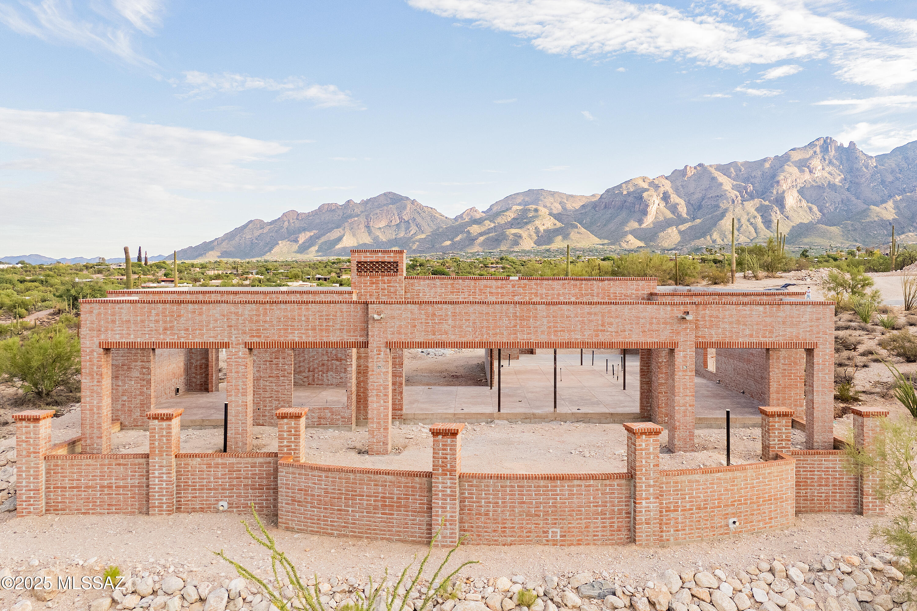 This new construction 2,516 sq. ft. home is more than a style. Contemporary desert vernacular is an architectural language grounded in place, according to local architectural historian R. Brooks Jeffery, respecting the delicate Sonoran Desert environment, and incorporating time-honored design principles with contemporary interpretations that reflect the cultural characteristics unique to Tucson. Situated on .83 acres in the gated Quintana in the Catalina Foothills, this residence offers unmatched city and mountain views and a level of construction quality rarely seen in today's new builds.

Designed by renowned architect Michael Franks and brought to life by La Quinta Building Company, this 2-bedroom, 2 ½-bath is being built to endure, featuring masonry construction