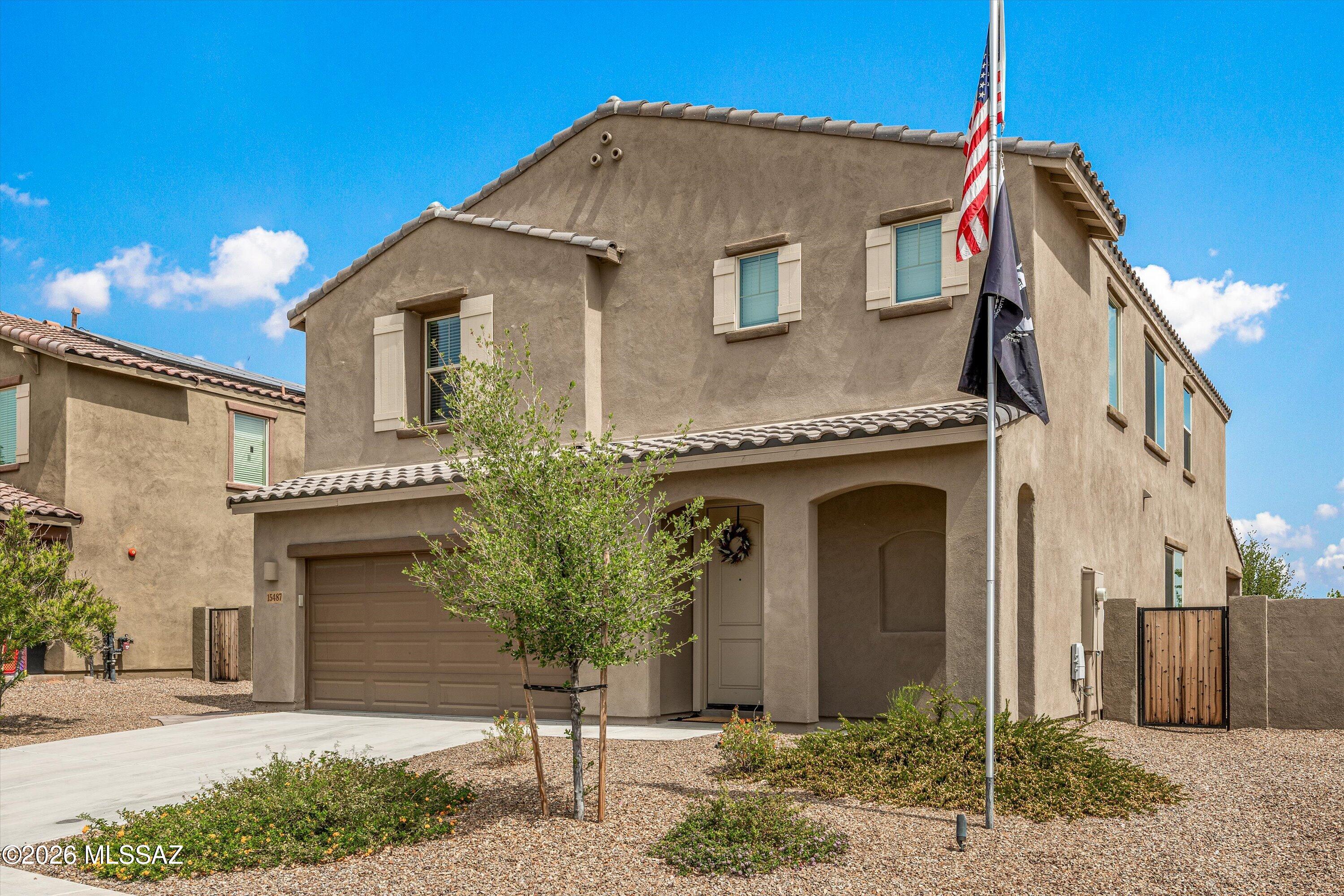 Located in the award-winning Rancho Sahuarita community, this newer home offers an exceptional blend of comfort, location, and lifestyle. Ideally situated near one of the community's satellite pools, your home enjoys close proximity to the volleyball and basketball courts, playground, Safari Trail, butterfly garden, splash pad, fitness center, grocery stores, and many additional amenities that make Rancho Sahuarita such a special place to live. With year-round activities and events for all ages, this community truly supports an active, connected lifestyle.
The backyard is a standout feature, offering incredible value and designed to fully enjoy Arizona's outdoor living. The extended fully covered patio with beautiful brick pavers creates an inviting space for relaxing or entertaining while taking in peaceful mountain views. A gas fire pit adds warmth and ambiance, and the extra-wide side yard offers potential for a future double gate, providing flexibility and convenience.
Inside, the popular open concept floor plan offers just under 3,000 sq. ft. with a highly functional layout. The kitchen features a large island and a walk-in pantry that  flows seamlessly into the main living areas. A first-floor bedroom with its own en-suite bath provides ideal space for guests or multigenerational living. Upstairs, you'll find a spacious loft, four additional bedrooms, and a conveniently located laundry room. The primary suite offers an expansive layout and generous walk-in closet.
 A three-car garage provides ample space for parking, storage, or hobbies.
Enjoy the lifestyle Rancho Sahuarita is known for, with scenic trails, parks, community events, and amenities designed for all stages of life. Whether relaxing in your private backyard or enjoying everything the community has to offer, this home provides the perfect opportunity to live your best life.