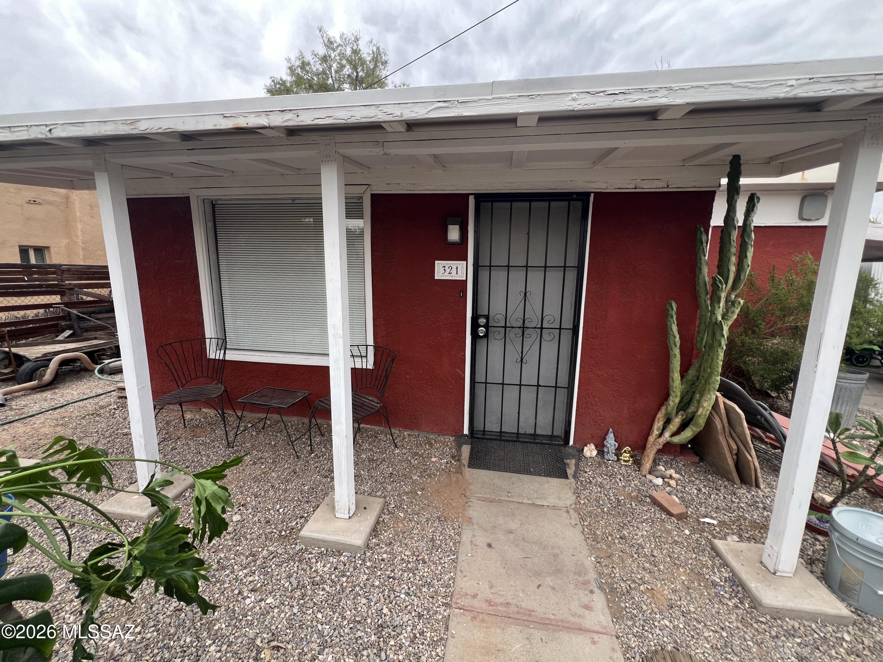Centrally located remodeled house..  Kitchen remodeled with new cabinets, countertops, and appliances.  Bathroom remodeled with new shower, vanity, and toilet.  Private off street parking behind the fence.  Mini-Split installed 2025.  New ceramic tile in bathroom, new laminate flooring in kitchen and bedroom  Laminate flooring in living room and bedroom, Tile flooring in Arizona room.  2.3 miles from the University of Arizona.  Bonus room.  Several yard ares separated by gates.  Patio area with pavers off the back door.  Covered workshop area off the carport.  This home qualifies for down payment assistance through approved lender.