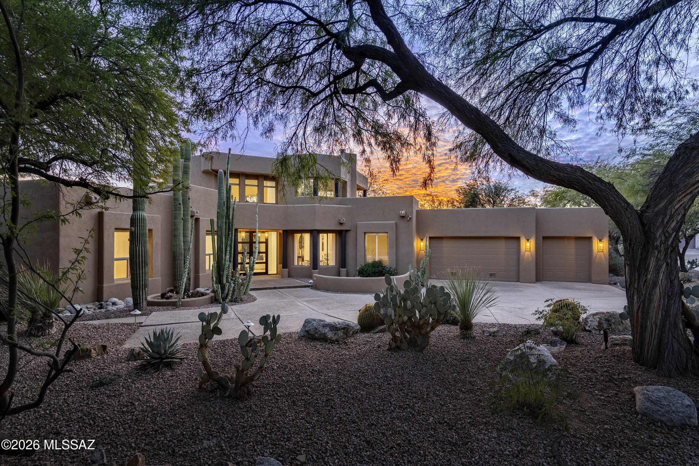 Nestled within the prestigious Ventana Country Club Estates, this timeless residence is thoughtfully designed with a refined sense of proportion, materiality, and detailing, effortlessly blending classic elegance with modern ease. The flexible floor plan, featuring 3 bedrooms and 3 bathrooms, seamlessly balances form and function, creating an inviting living environment where every detail has been carefully considered. Custom metal and glass entry doors open to a striking interior where volume and proportion take center stage. Volumes are generous, ceilings rise with purpose, and architectural lines frame expansive mountain views establishing an immediate sense of presence. The layout flows naturally, balancing openness with defined moments, and creating spaces that feel equally suited to intimate daily living and elevated entertaining. Multiple points of egress dissolve the threshold between indoors and out, cultivating a continuous spatial dialogue between the architecture and the curated lush landscapes beyond.

This kitchen is defined by restraint and balance, anchored by custom knotty alder cabinetry with subtle brass hardware, contrasted by a softly painted sand beige island that lightens the space while maintaining a tailored millwork language. Polished Quartz countertops and a horizontally laid white tile backsplash create a clean, architectural backdrop, softened by floating wood shelves and grounded by neutral stone tile flooring set on the diagonal. 

Professional grade appliances are seamlessly integrated, including a stainless steel French door refrigerator, gas range with a sculptural custom hood, built-in double ovens, a discreet dishwasher, and a glass front beverage refrigerator within the island, resulting in a kitchen that feels elevated yet effortless. Flowing seamlessly into the adjoining dining and formal living areas, the kitchen fosters an atmosphere that encourages both gathering and quiet reflection.

The primary suite is privately positioned on the northeast end of the residence, featuring a large open walk-in dressing closet and a spa-like bathroom with a walk-in shower and separate soaking tub. Adjacent to the suite, the den/office overlooks the front courtyard with Catalina Mountain views. Thoughtfully designed with a split bedroom layout, the residence features two additional bedrooms, privately positioned within the west wing to comfortably accommodate guests and family alike. The second story is dedicated entirely to a single loft space, serving as a versatile retreat anchored by a cozy fireplace and opening to a covered balcony, where one can sit, relax, and savor sweeping desert views as the evening skyline transforms with a breathtaking display of sunset hues.

Encircling the home, a series of thoughtfully positioned outdoor living spaces create an effortless flow between shelter and landscape. Here, one is fully immersed in the tranquility of the natural surroundings. The sun-drenched terrace, designed for seamless indoor-outdoor living, offers al fresco dining. Overlooking a resort-like pool, this space serves as an extension of the home, a place where everyday living and lifestyle exist in perfect harmony.