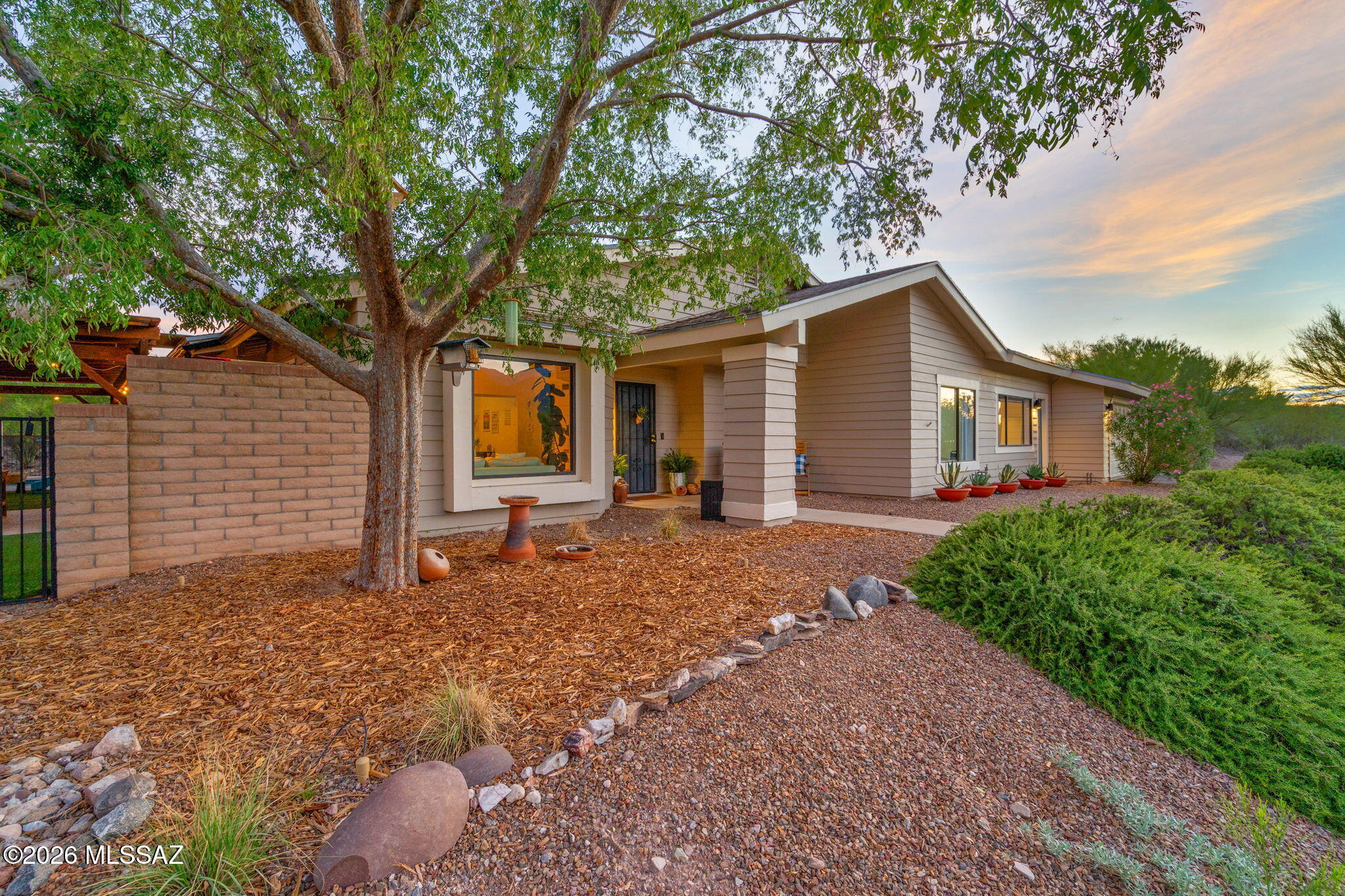 Situated on an elevated .93 acre lot in the highly sought after TV Valley & Tanque Verde School District, this 3 bed 3 bath home offers abundant natural light, vaulted ceilings, stunning Catalina Mountain views, tile throughout, updated modern light fixtures, water softener, RO system in kitchen & blackout cellular shades. The versatile bonus room with a separate entrance offers a new mini split, recessed lighting and half bath, perfect for a home office, studio, guest space or gym. Step outside to your backyard retreat featuring a sparkling newly refinished solar heated Pebble Tec pool, cedar pergola with metal roof, shaded turf & paved seating area, water harvesting, raised garden beds and additional space ready to make your own plus an extended length 2 car garage. Welcome home!