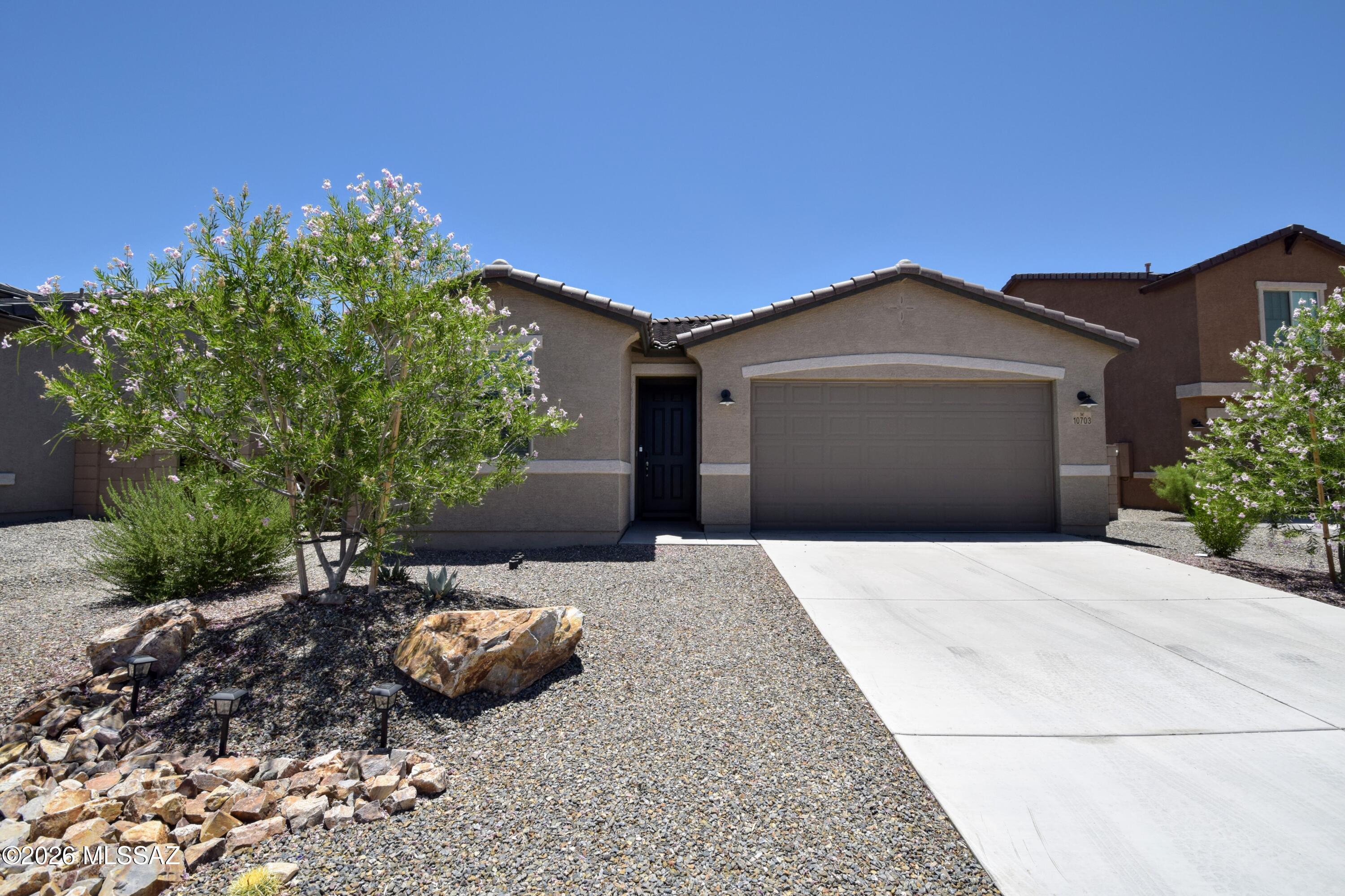 Located in the highly desirable Gladden Farms master-planned community of Marana, this beautiful 1,590-square-foot single-family home offers modern comfort and peaceful living with no neighbors to the north or south. This single-level residence features an ideal split bedroom floor plan with three bedrooms and two bathrooms, supplemented by ceiling fans in all rooms alongside efficient central air conditioning and central air heating systems for year-round comfort. The heart of the home is an open-concept living area showcasing a functional kitchen island with a breakfast bar, ample cabinets, and generous counter space. An oversized patio door floods the living area with natural light and leads out to a fully fenced yard featuring a covered patio with an extended brick paver area and easy- care landscaping, making it perfect for low-maintenance outdoor relaxation. The spacious primary suite serves as a private retreat, boasting an attached primary bathroom equipped with a dual-sink vanity, a walk-in shower, and an oversized walk-in closet. For maximum convenience, the home includes a spacious three-car tandem garage and a dedicated indoor laundry setup with a full-size washer and dryer included. This home is offered to NON-SMOKING tenants ONLY. The pet policy allows for well-behaved dogs to be considered on a case-by-case basis, though no cats are permitted on the premises.