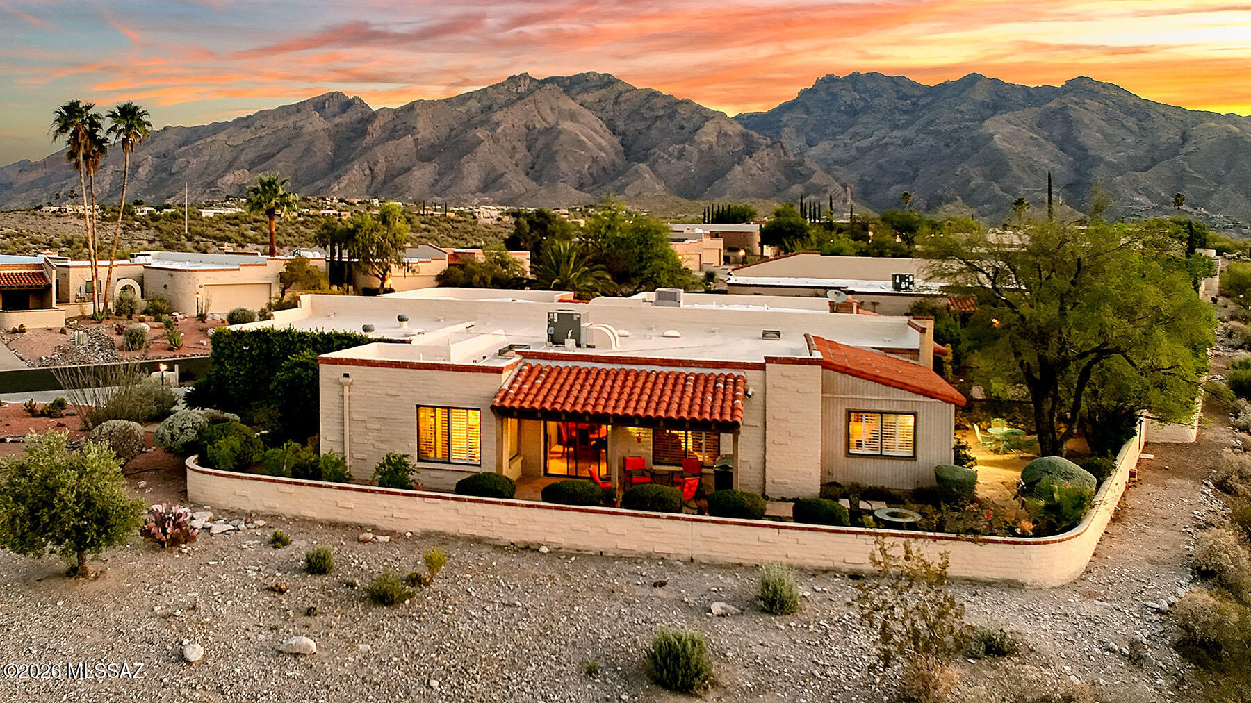 Perched high on a Ridgetop with adjacent open space within Fairfield's Sunrise Ridge-Catalina Foothills, this incredible single-story TH offers the ultimate in ideal desert living w/ sweeping panoramic views of the mountains and lush Sonoran desert by day&sparkling city lights by night. Home features a flowing split bedroom plan, multiple living areas all accessing wrap around outdoor patios The primary suite's cozy ambiance enjoys a remodeled ensuite bath w/separate shower. Secondary suite boasts artful remodeled bath w/glass bowel sink. Expansive windows&open living spaces maximize the extraordinary views, while the single-level layout creates ease of living&flow. An exceptional combination of location,design&comfort-this updated, well maintained home is as inspiring as its surroundings!