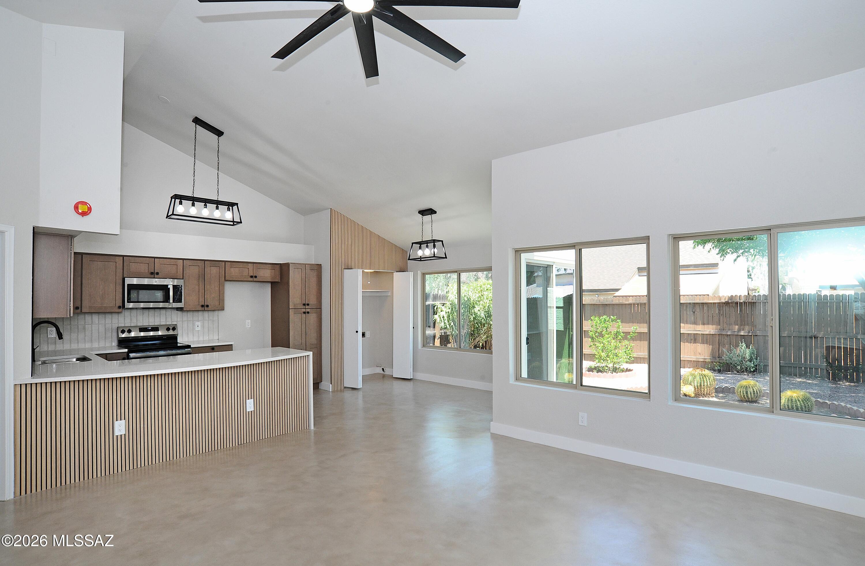 Range priced seller will entertain offer between $300,000-$310,000. Meet your new home! Beautifully updated TH in wonderful conveniently located near east side subdivision. Corner unit with two car garage, open floor plan with huge island and curved quartz countertops. New kitchen, concrete floors, fresh paint inside and out, new shingles and new fixtures. 2 car garage with storage and nice backyard with a squint of a mountain view. You will love this location!!!!  Owner/Agent